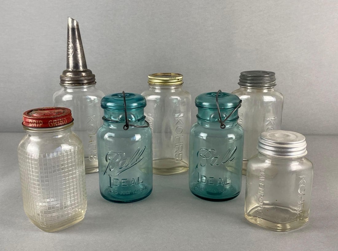 Group of 7 Glass Mason Jars and More: Includes Kohrs Motor Oil Jars, Aqua Blue Ball Jars, and Manor House Coffee, Largest measures 12 1/2 x 4 1/4 x 3 1/4 inches.