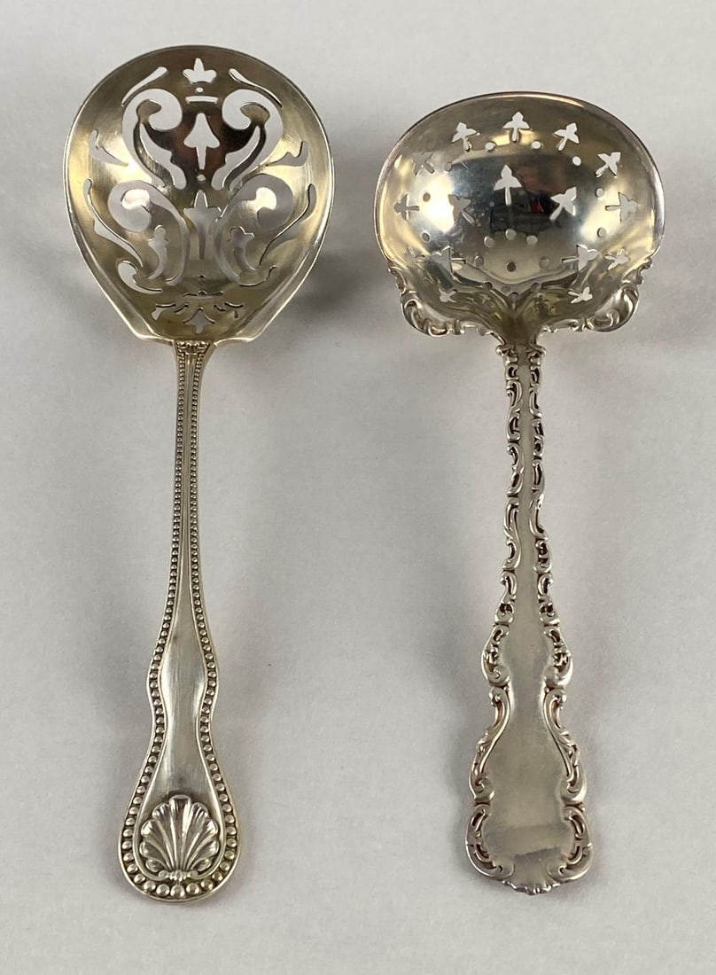 Group of 2 Sterling Silver Sugar Sifter Spoons: Total weight 57.8g, Includes Geo. Wolf Acanthus Leaves and Bead Design, and other, Largest measures 6 inches long.