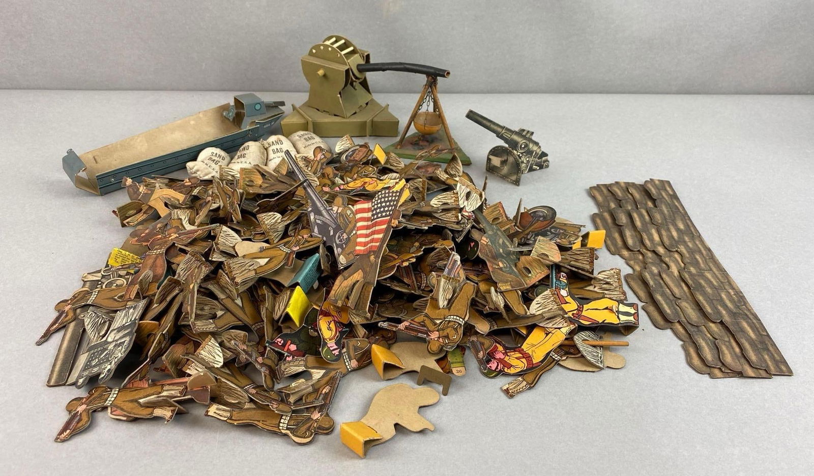 Group of Assorted Cardboard Army Men and More: Includes army men, artillery, boat and more, largest measures 4 1/4 x 7 1/4 x 5 inches