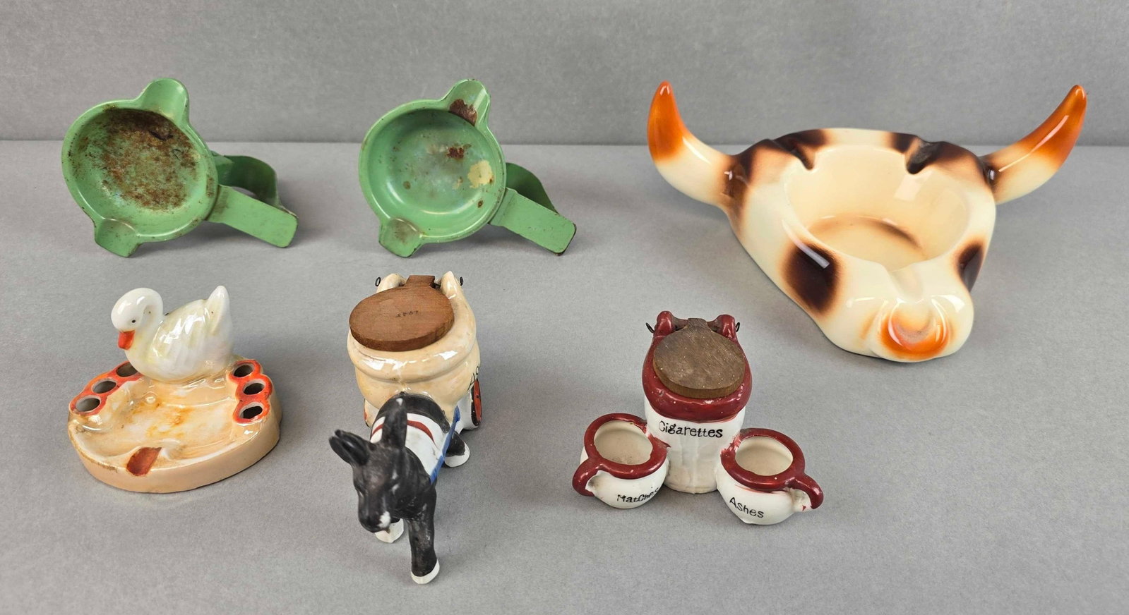 Group of 6 Cigarette Ashtrays: Includes metal ashtrays, bull pottery ashtray, goose ashtray and more, largest measures 3 1/4 x 8 1/2 x 6 inches