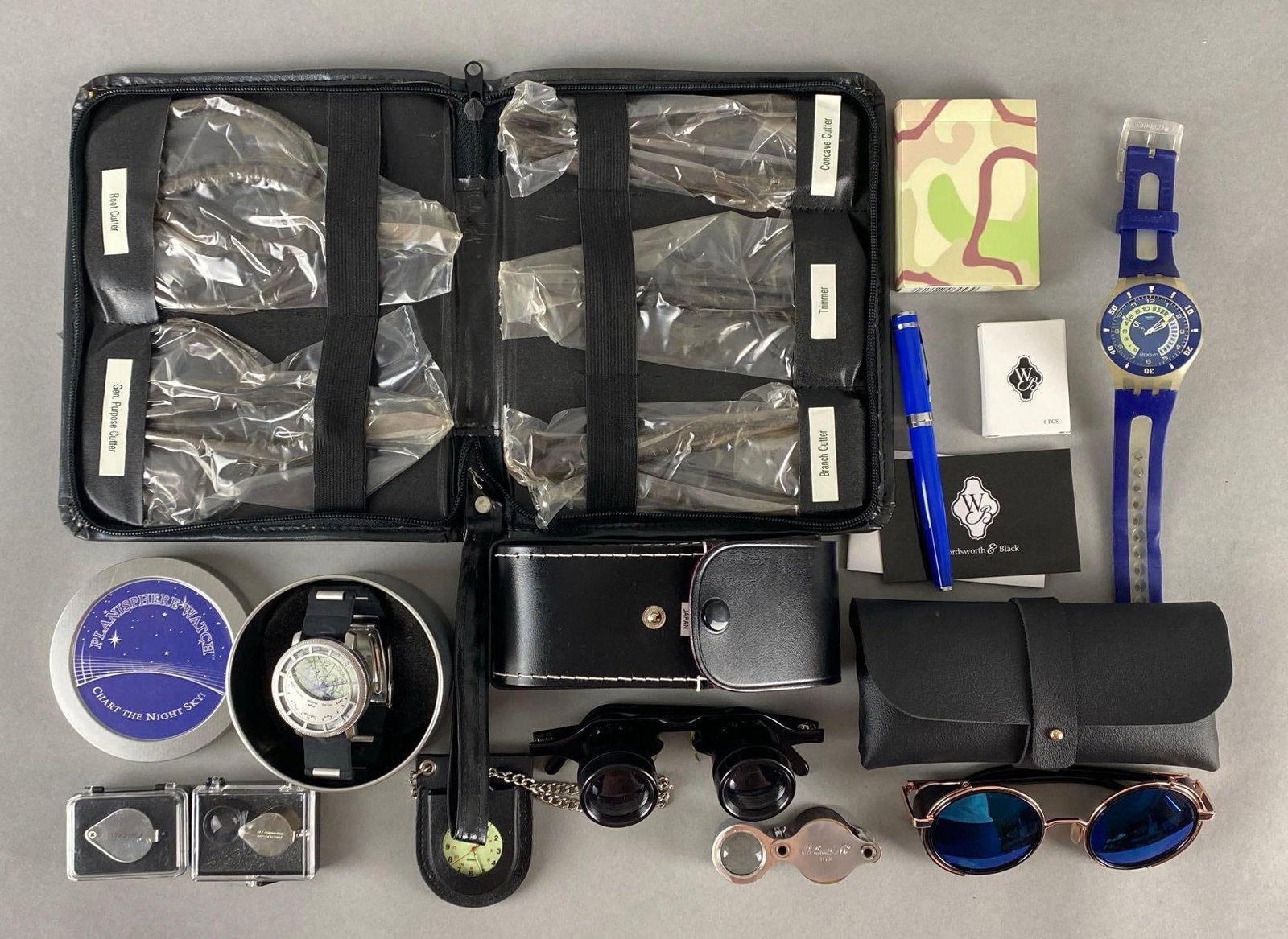 Group of Group of 16 Assorted Items: Includes watches, tools, binocular glasses, deck of cards, and more, Largest case measures 9 x 7 1/2 x 1 inches.