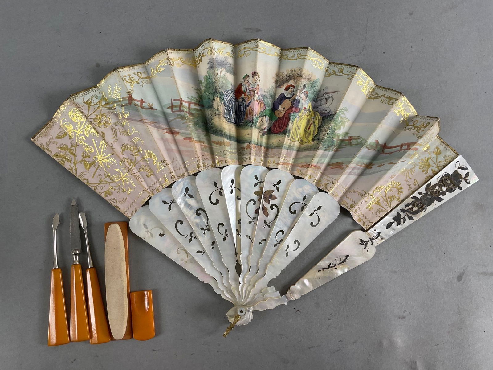 Ornate Fan and Bakelite Nail Care Set: Mother of Pearl fan is broken in a few spots. Measures 10 1/2 inches