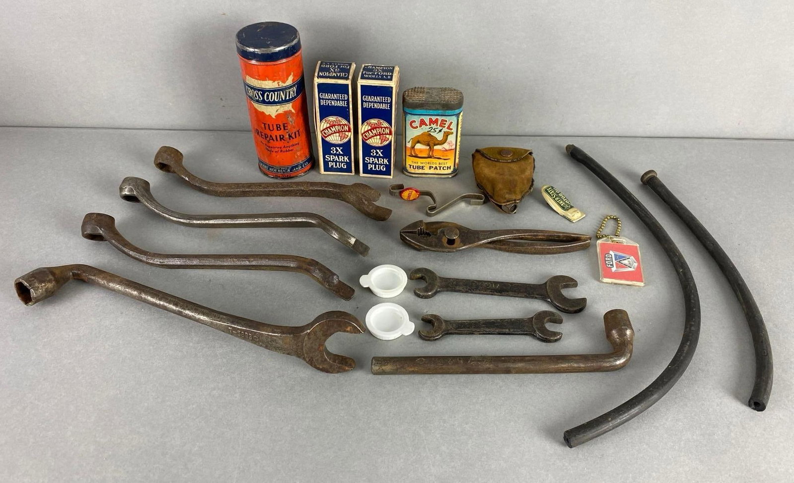 Group of 20 Assorted Tools and More: Includes tube repair kit, spark plugs, tube patch and more, front most wrench measures 11 1/4 x 3 x 2 inches