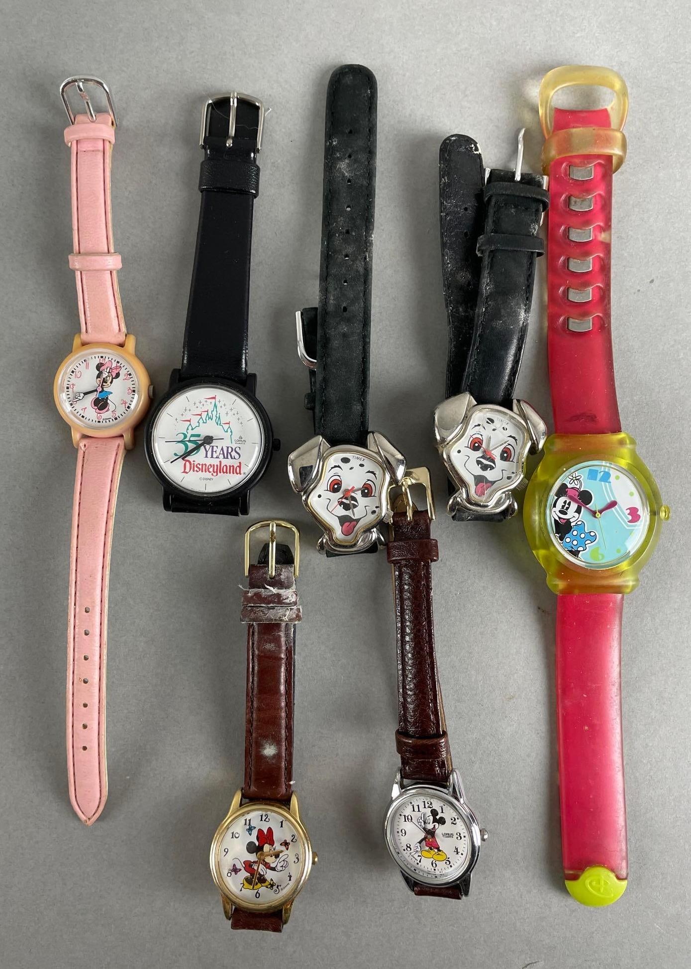 Group of 7 Walt Disney Wristwatches: Includes 35 years Disneyland, Minnie Mouse, Mickey Mouse, 101 Dalmatians. Untested. Longest measures 9 inches