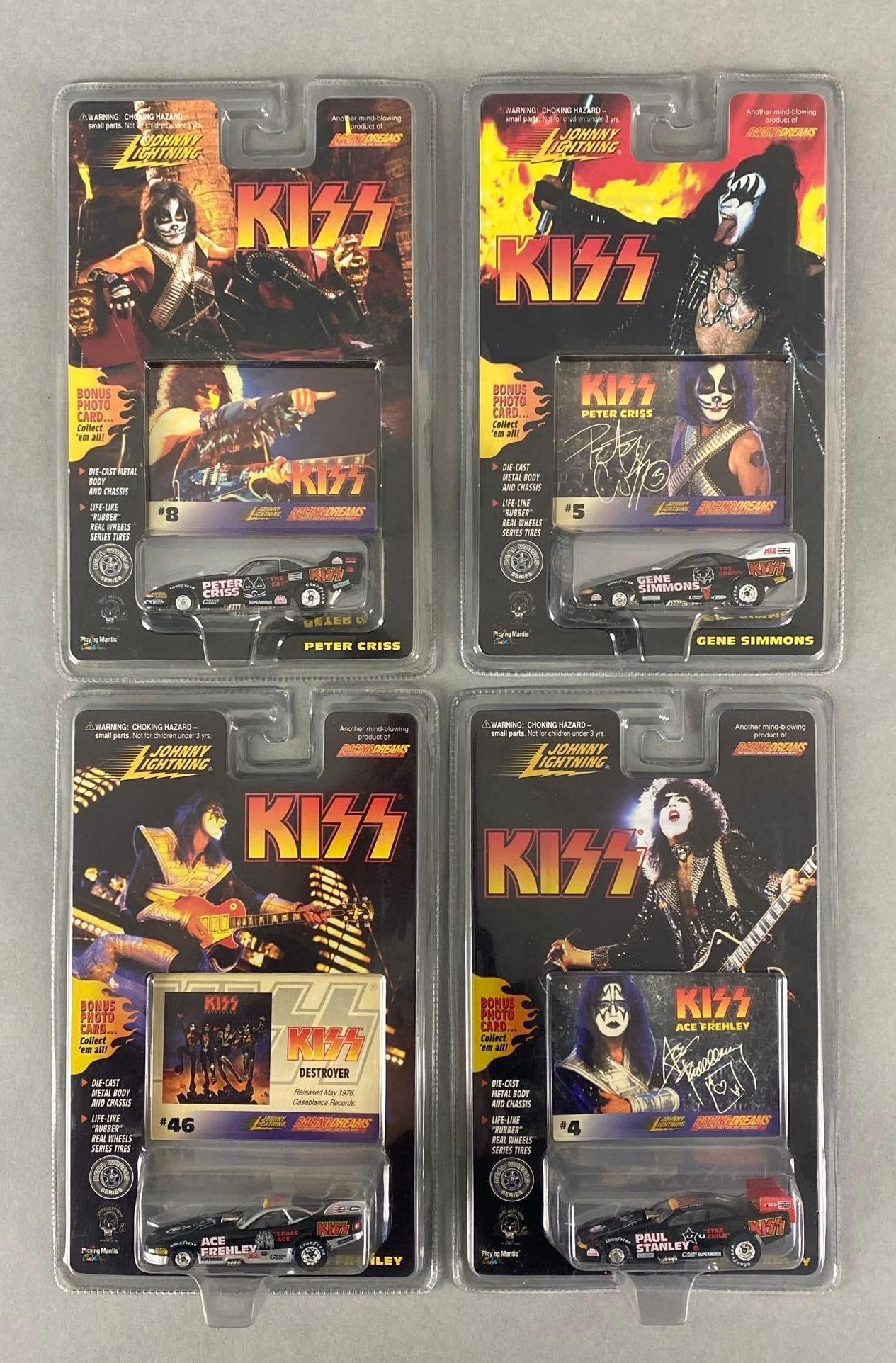 Group of 4 Johnny Lightning KISS Die-Cast Vehicles: 1997, Playing Mantis, Includes Ace Frehley, Paul Stanley, Peter Criss, and Gene Simmons, In original packaging, Packaging measures 9 1/2 x 6 x 1 3/4 inches.