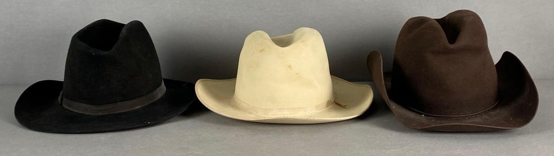 Group of 3 20th Century Fox Western Hats: Wardrobe design hats, Includes black, brown, and white, Some stains, Largest measures 6 1/2 x 15 x 9 inches.