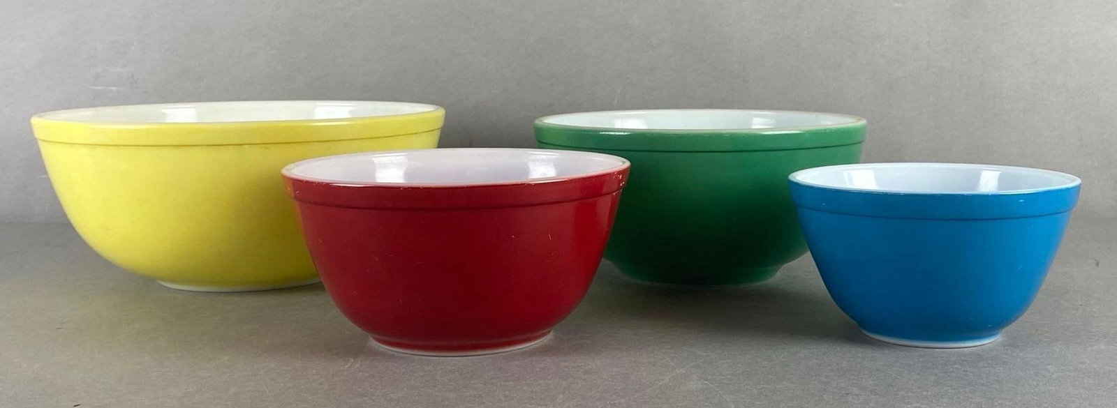 Group of 4 Vintage Colorful Pyrex Mixing Bowls: Makers mark on bases, Some discoloration, Largest measures 4 1/2 x 10 1/2 x 10 1/2 inches.