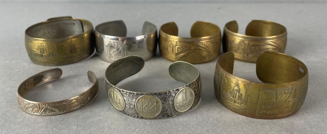 Group of 7 - 1933-34 Chicago Worlds Fair Metal Cuff Bracelets: arg measures 1 x 2 1/4 inches