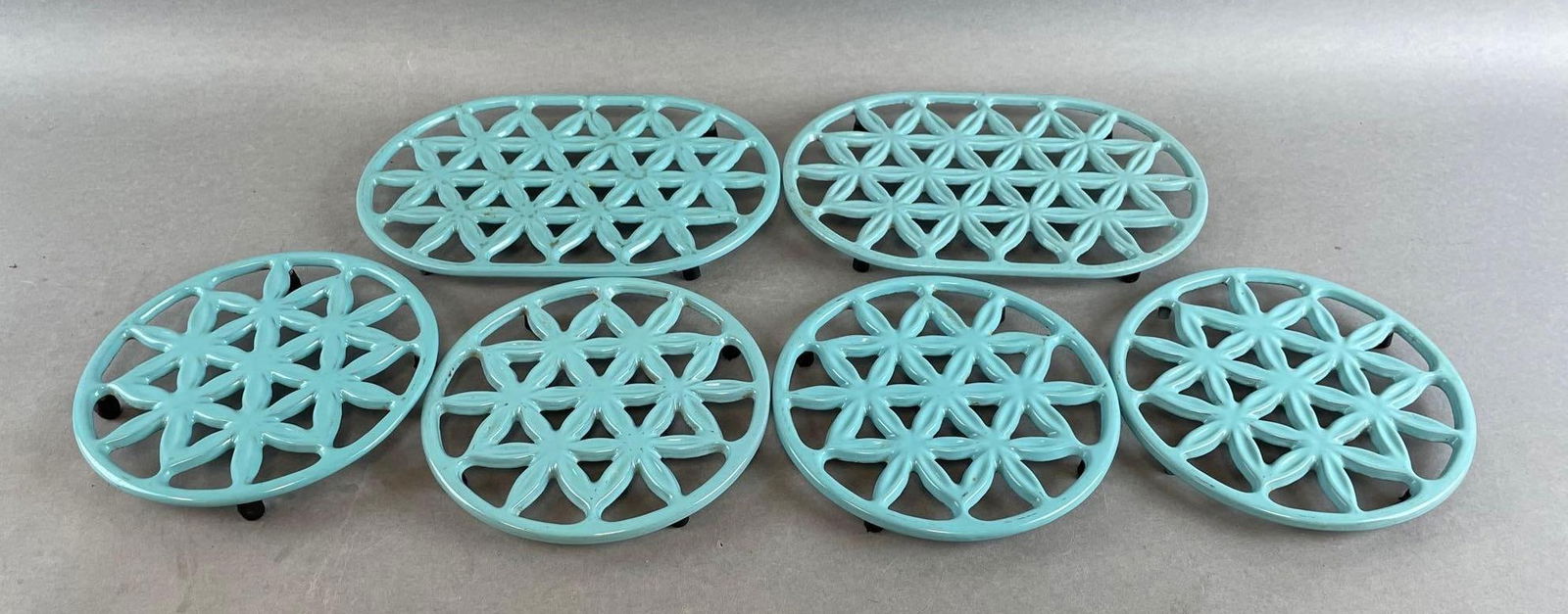 Group of 6 Prizer-Ware Cast Iron Trivets: Includes pamphlets, largest trivet measures 9 1/4 x 6 1/4 inches