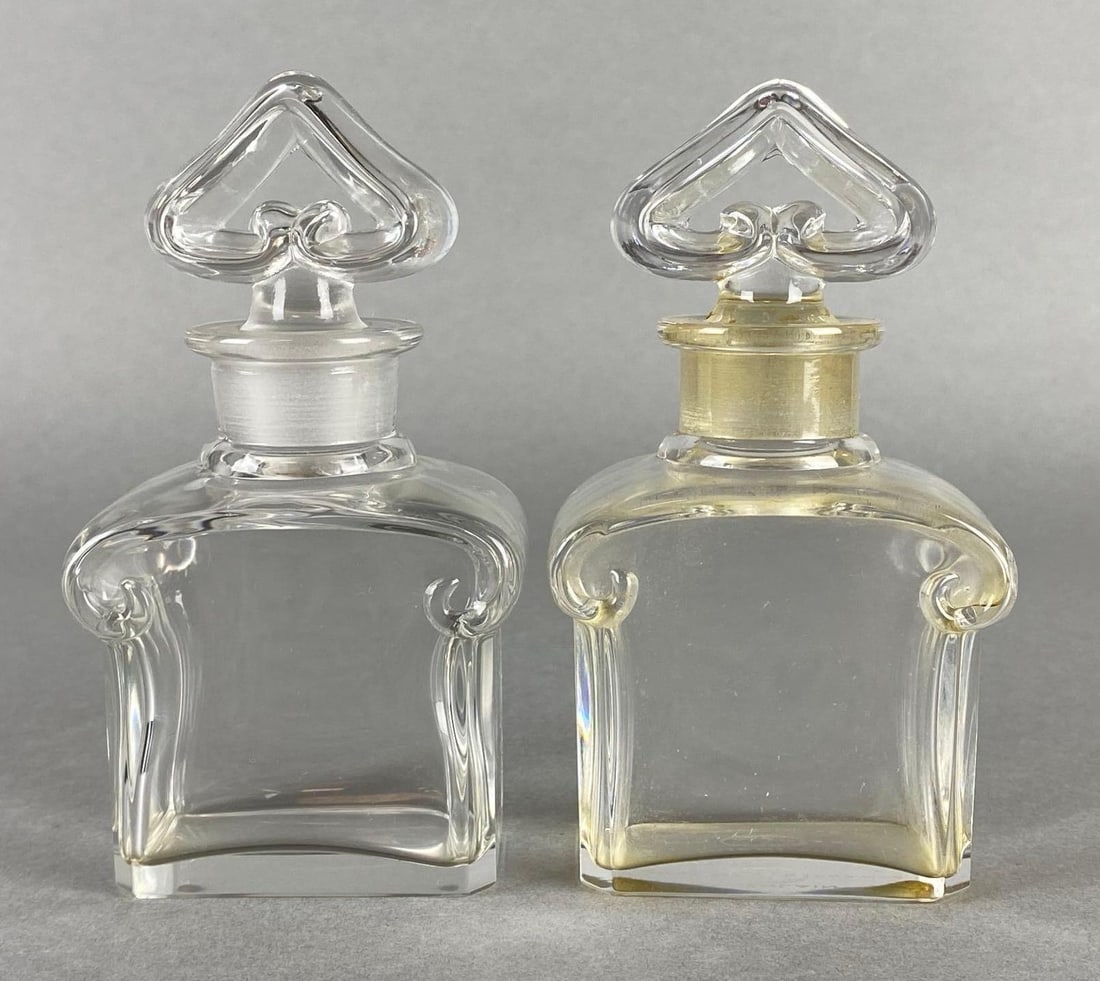 Group of 2 Baccarat Guerlain Clear Glass Perfume Bottles: Made in Paris France, With original stoppers, One with makers mark on base, Both measure 4 3/4 x 2 1/2 x 1 3/4 inches.