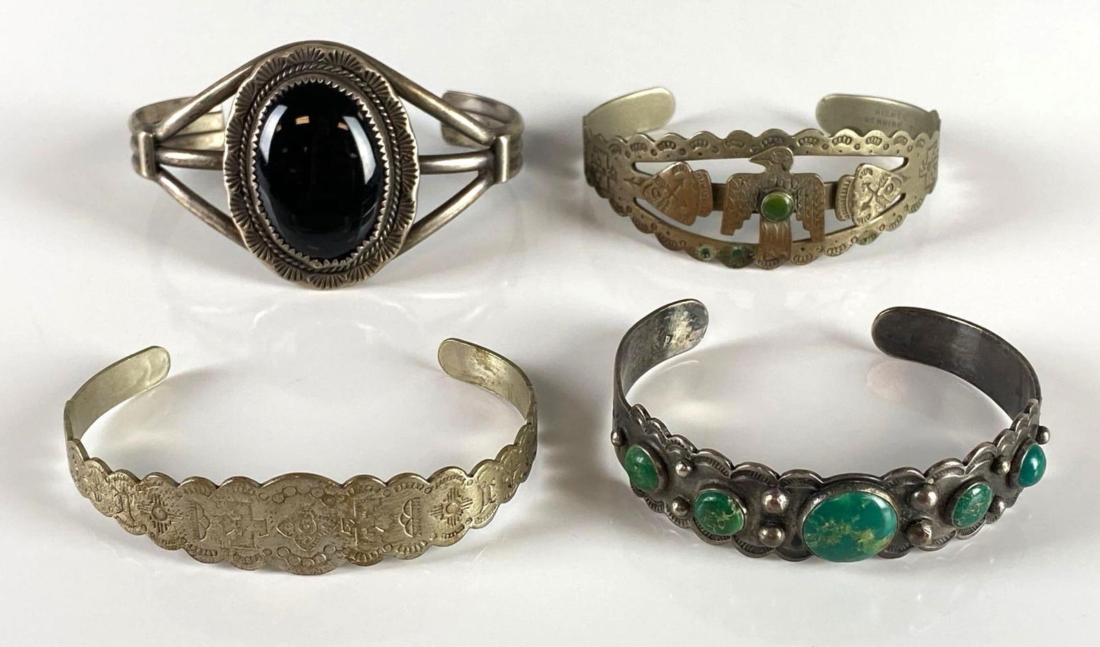 Group of 4 Native American Cuff Bracelets and More: Includes coin silver, nickel silver, and more, Largest measures 8 inches around.