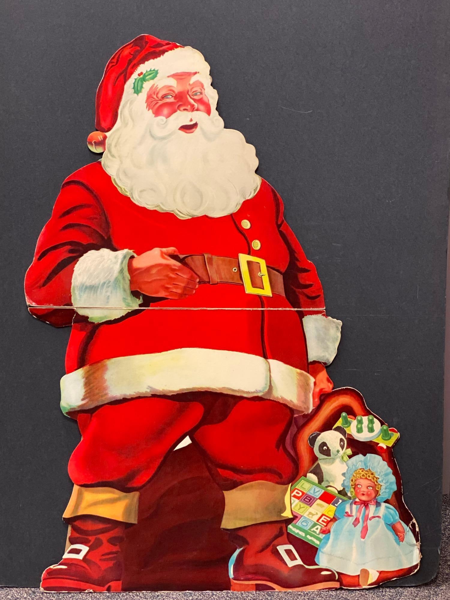 Cardboard Stand Up Santa Claus: Not connected at mid section, tears and creases throughout edges, measures 57 x 41 inches