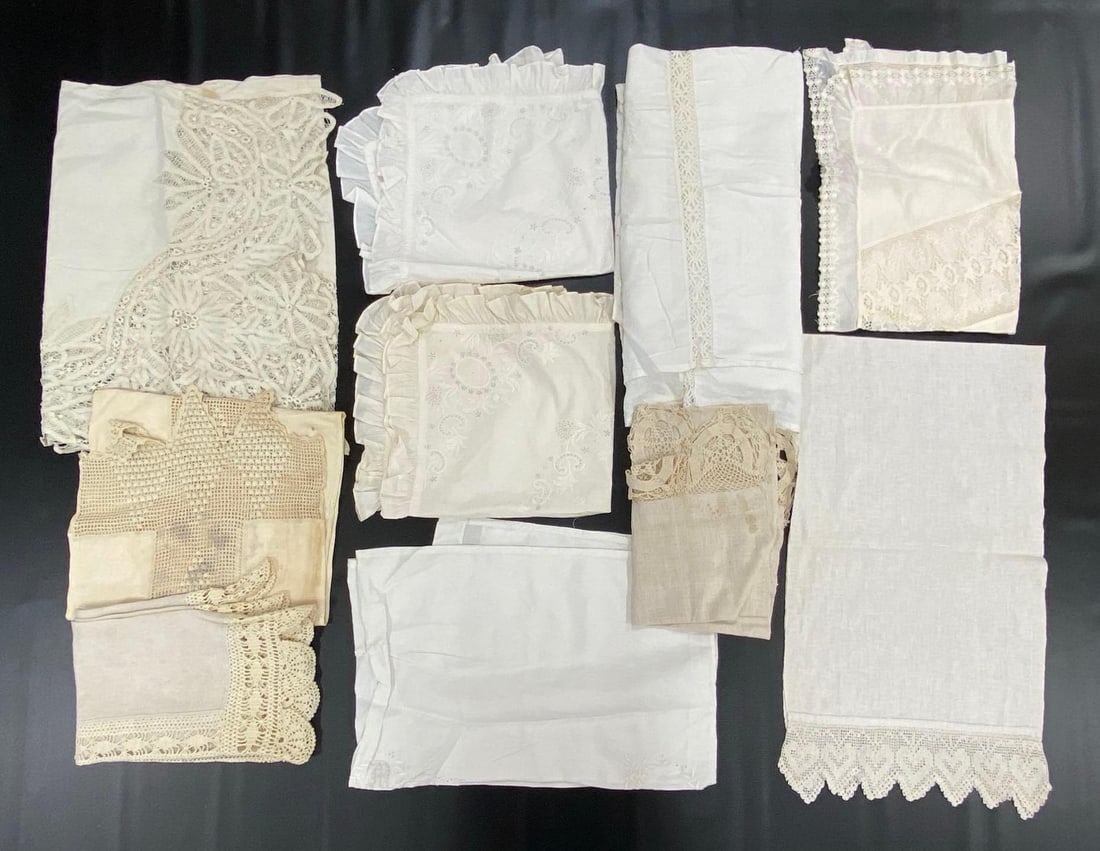 Group of 10 Vintage Lace Linens: Includes pillowcases, table runners, flat sheet, and more, Some staining throughout, Largest measures 100 x 82 inches.
