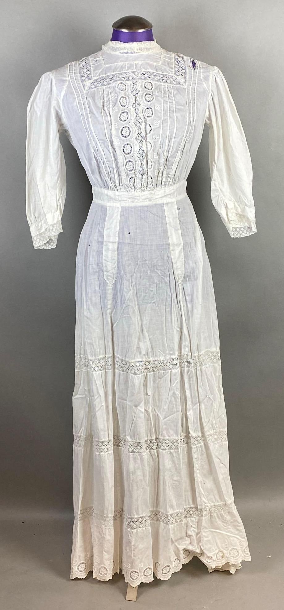 Victorian White Lace High Neck Petticoat: Some small holes scattered throughout, Large tear along top left shoulder, Shoulder to shoulder measures 15 inches, Overall length measures 50 1/2 inches.