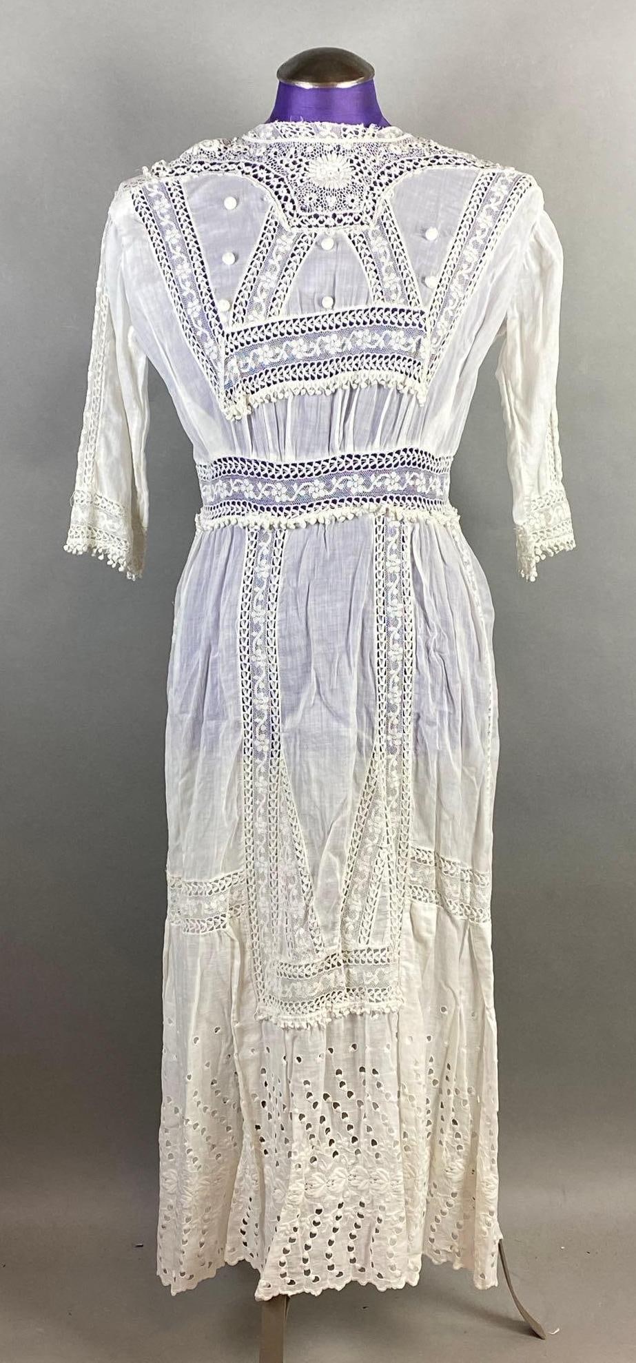 Victorian White Lace High-Neck Petticoat: Some small holes and tears scattered throughout, Shoulder to shoulder measures 15 1/2 inches, Overall Length 46 inches.