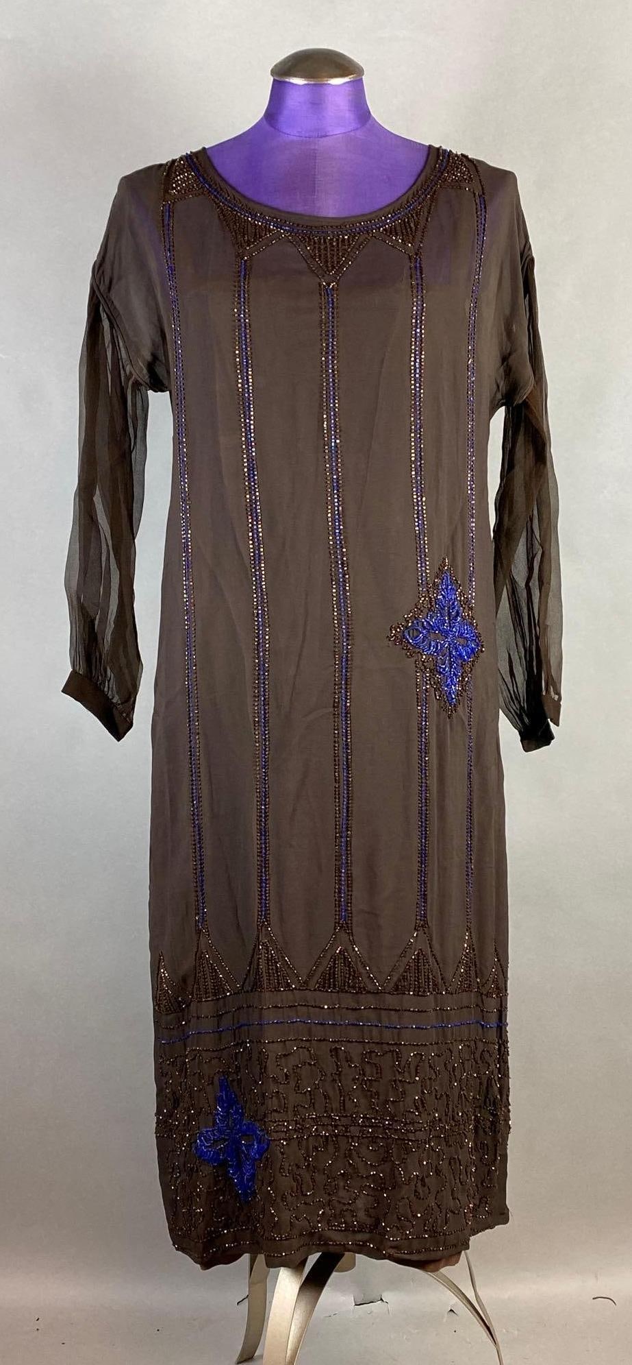 Vintage Brown Beaded Drop Shoulder Dress: With separate brown underlining, Blue and copper/brown beaded patterning, Shoulder to shoulder measures 19 inches, Overall length measures 45 inches.