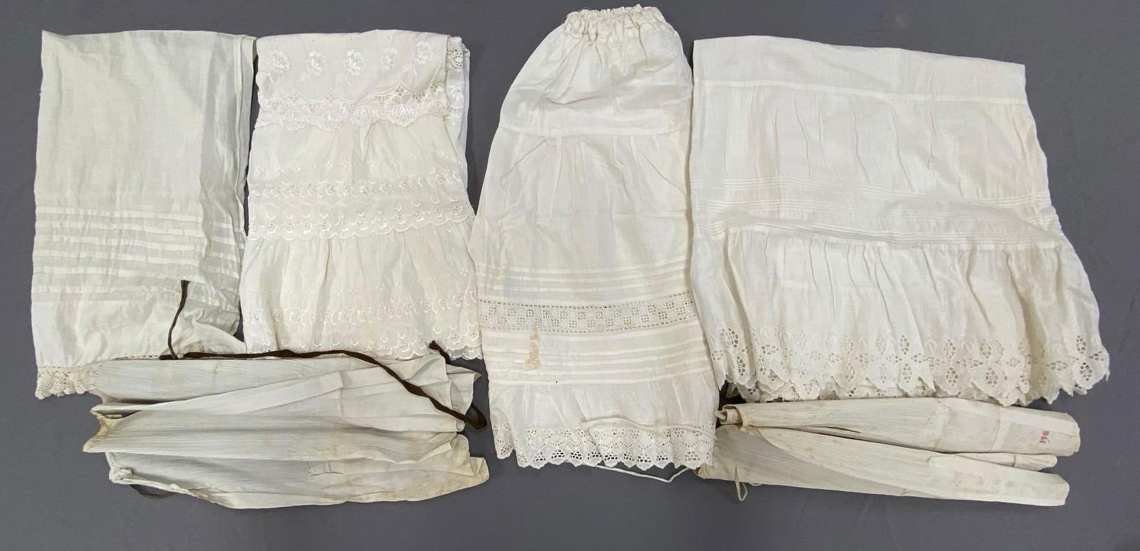 Group of 6 White Linen Womens Accessories: Includes garters, slips, and more, Some small stains throughout, Largest measures 36 inches long.
