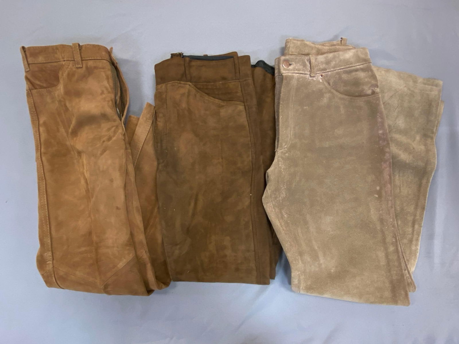 Group of 3 Pairs of Brown Leather Pants: One with tag from Robert Lewis Size 32, All with some wear, One with staining along front.
