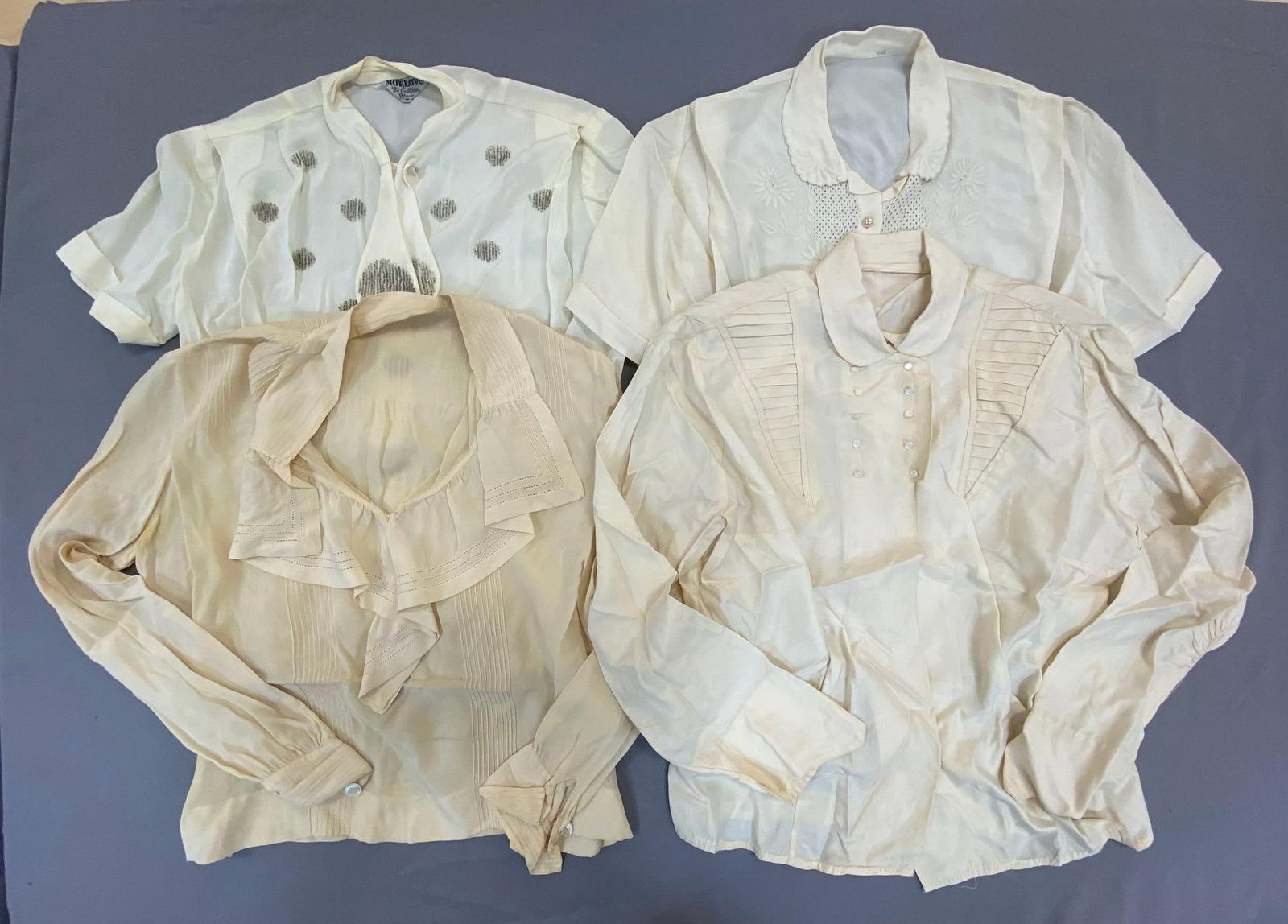 Group of 4 White/Off-White Womens Blouses: Includes MorLove, and 3 without tags, All approximately size Small, Includes 2 short sleeve, and 2 long sleeve, Some small stained spots.