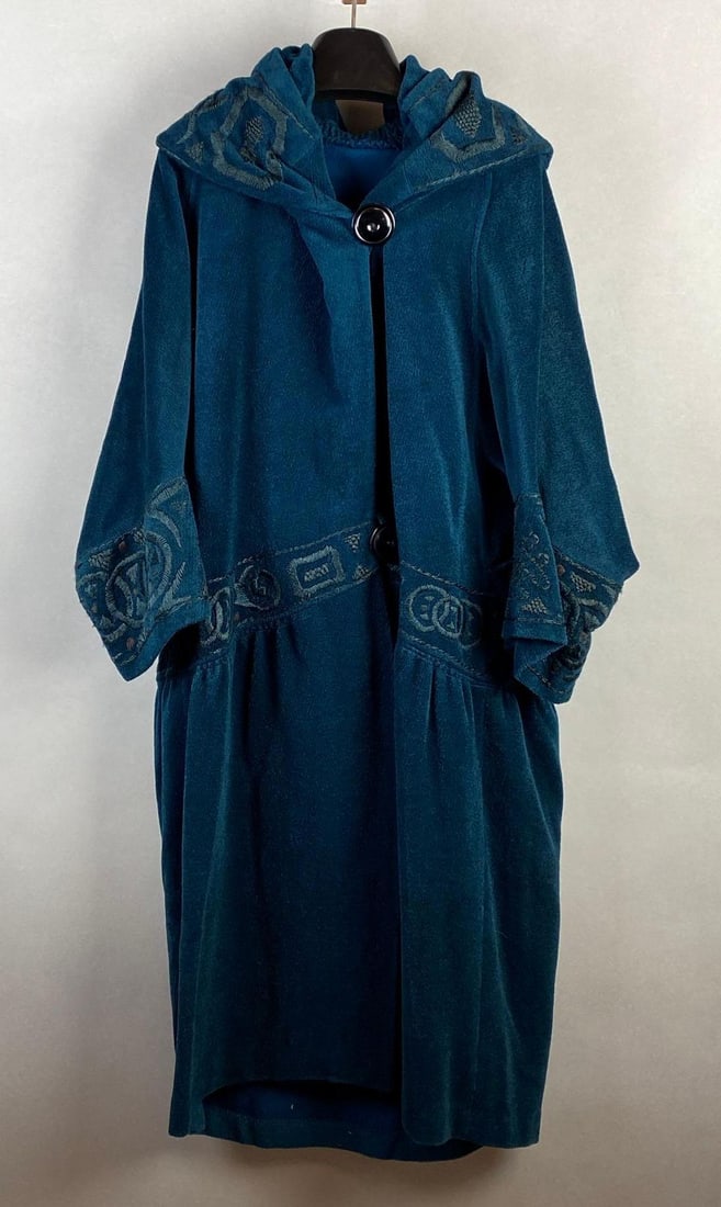 Vintage Teal Embroidered Housecoat with Caped Back: Appears homemade, Shoulder to shoulder measures 16 inches, Shoulder to cuff measures 20 1/2 inches, Collar to hem measures 43 1/2 inches.