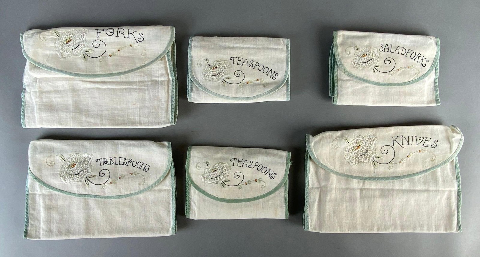 Group of 6 Arts and Crafts Embroidered Cloth Flatware Holders: Includes forks, knives, tablespoons, teaspoons, and salad forks, For 12 place setting, Largest measures 7 3/4 x 11 inches folded.