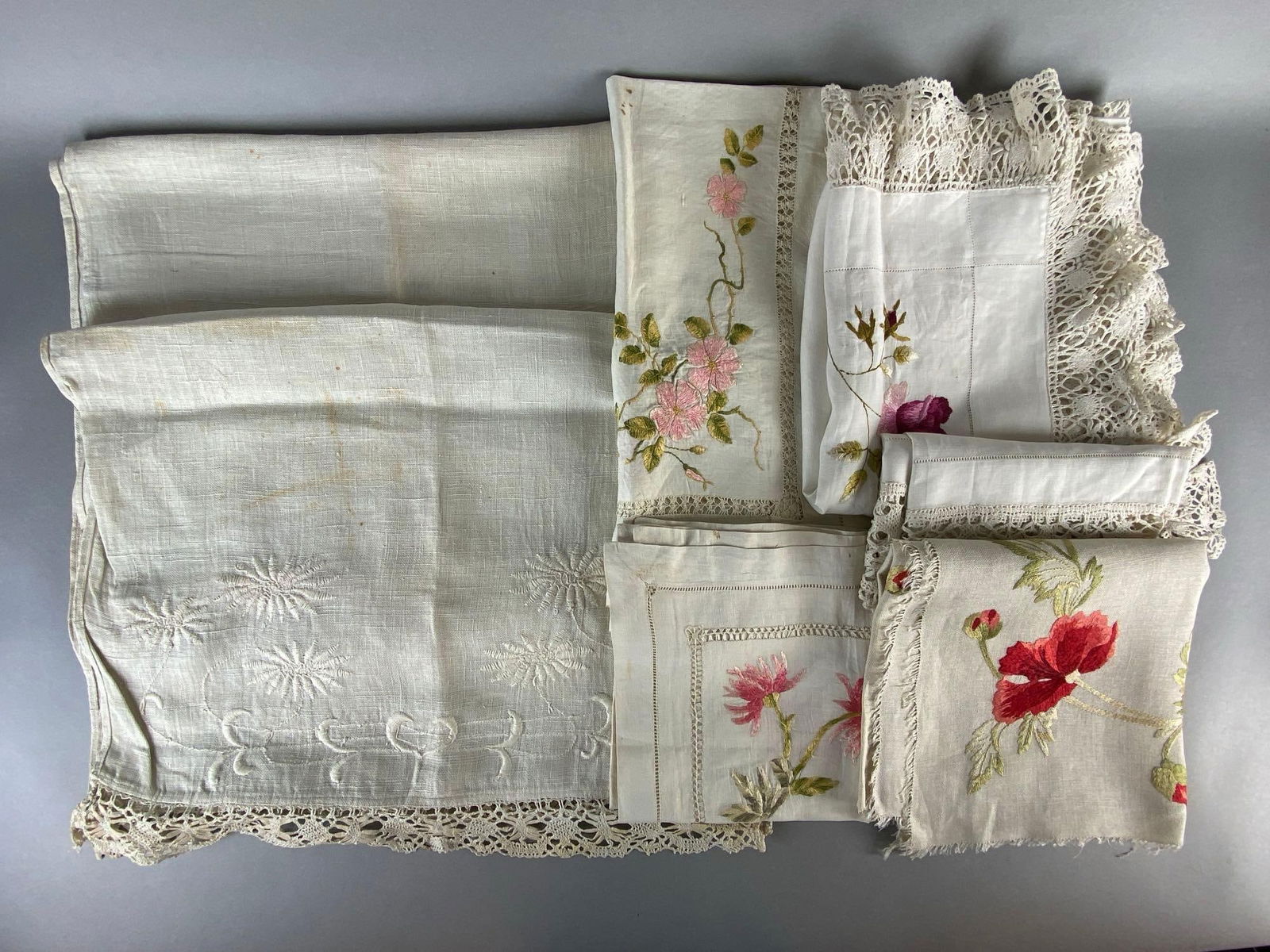 Group of 7 Floral Embroidered Table Runners and More: Most with lace edges, Some small stains throughout, Largest measures 70 x 21 1/2 inches.