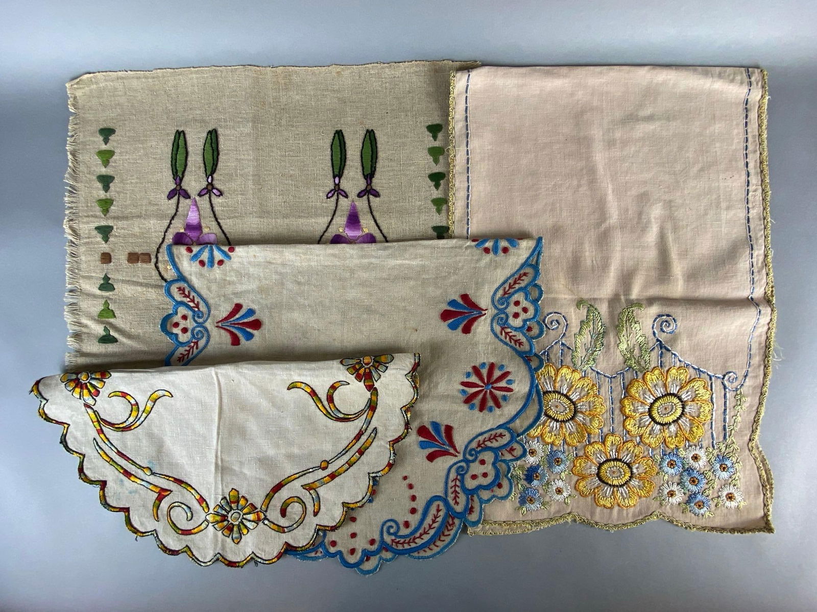 Group of 4 Embroidered Linen Table Runners and Centerpiece Mats: Largest measures 46 x 16 inches.
