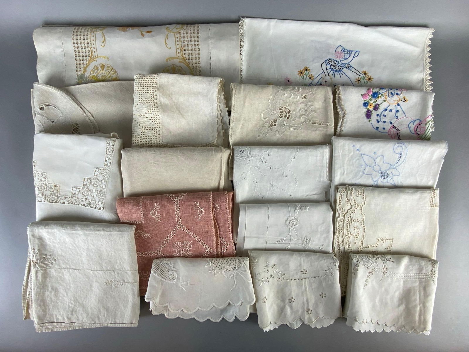 Group of 17 Tabletop Linens: Includes table runners, doilies, and more, Includes embroidered and lace, Largest measures 17 x 32 inches.