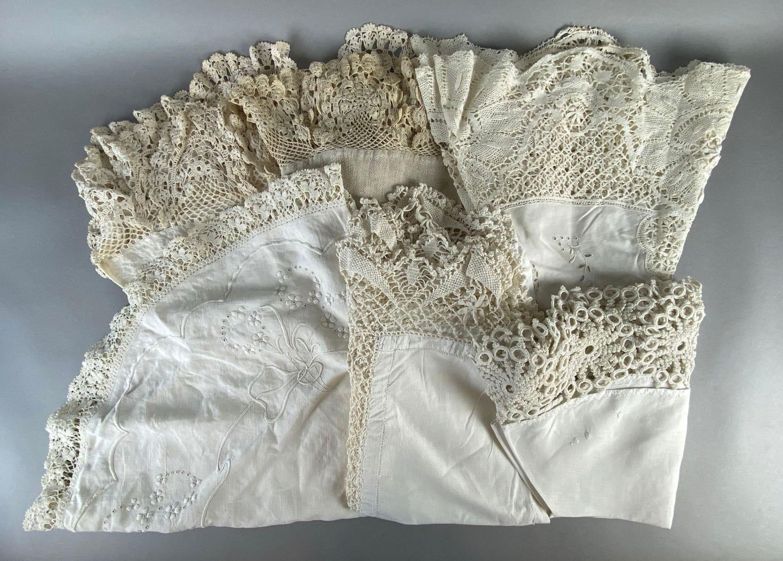 Group of 6 Round Linen Embroidered Tablecloths: Embroidered florals, Largest measures 49 inches across.