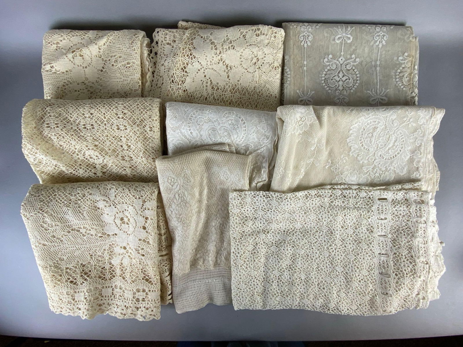 Group of 9 Lace Window Treatments: Includes curtains, valance, and swag, Largest measures 46 x 85 inches.