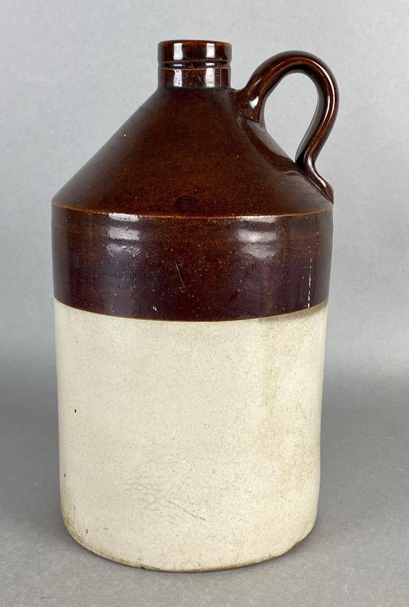 Monmouth Stoneware Whiskey Pottery Jug: Some Fleabites on rim, Measures 12 x 6 1/2 x 6 1/2 inches.