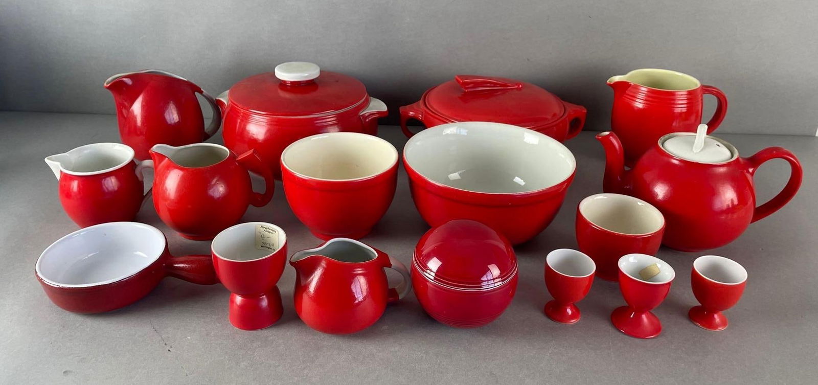 Group of 15+ Vintage Red and White Kitchenware: Mostly Halls kitchenware, includes Emile Henry, Czechoslovakian creamers, unmarked cups. Large bowl measures 4 x 7 1/2 inches