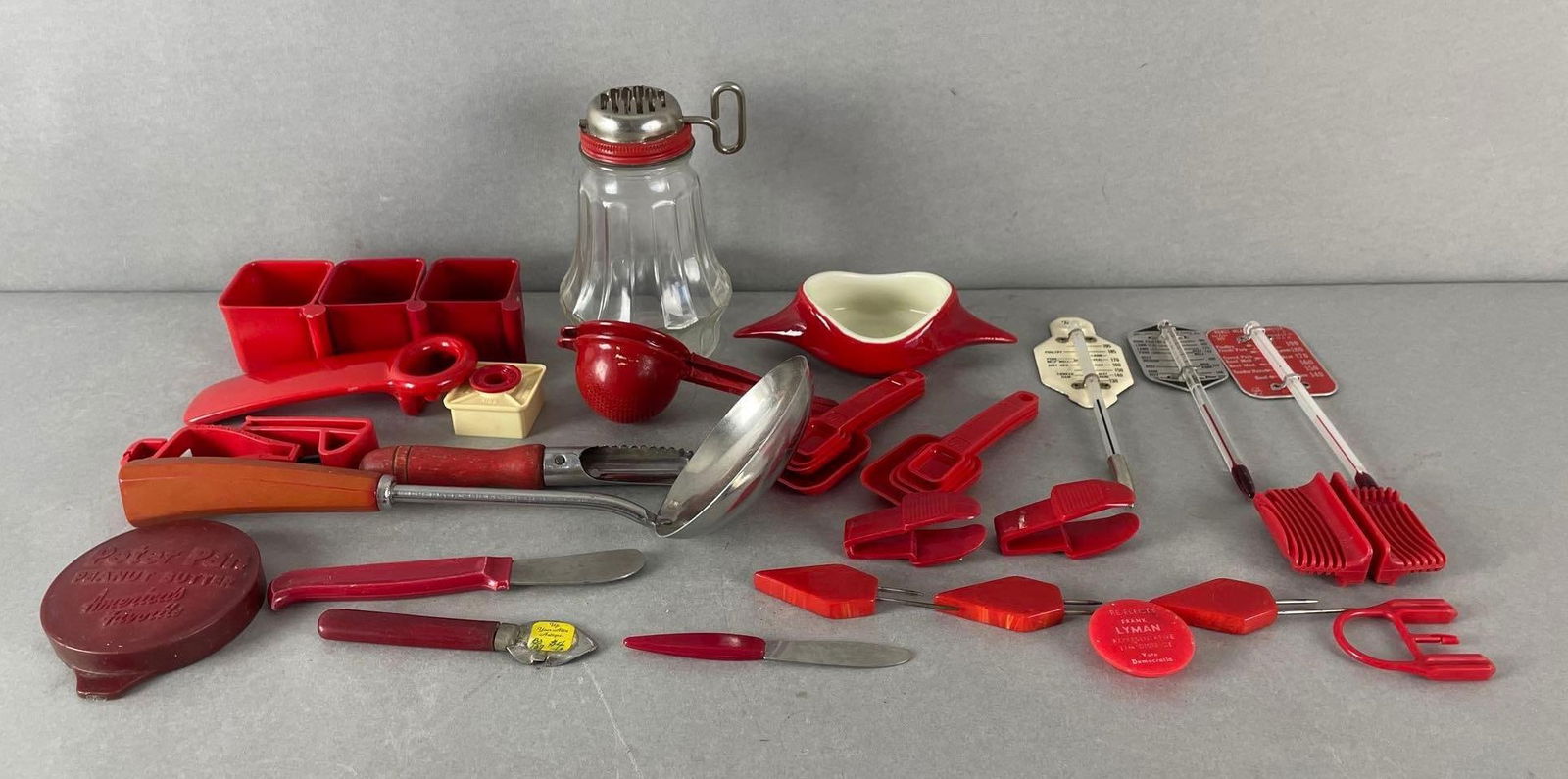 Group of Red Kitchen Tools and Utensils: Includes measuring spoons, Hills kitchenware dish, advertising, corn holders. Grater measures 5 1/2 x 3 1/2 inches