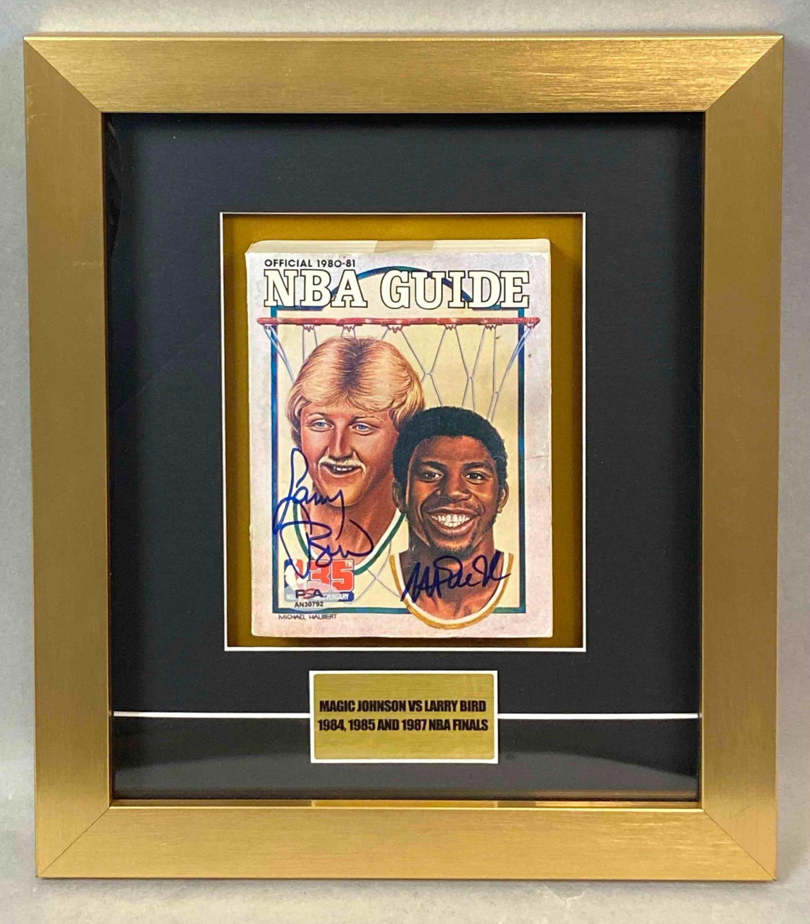 Framed Larry Bird and Magic Johnson Signed 1980 - 81 NBA Guide with PSA COA: Great early piece with both Bird and Johnson on the cover. This may be the only one of this Guide that is signed by both.