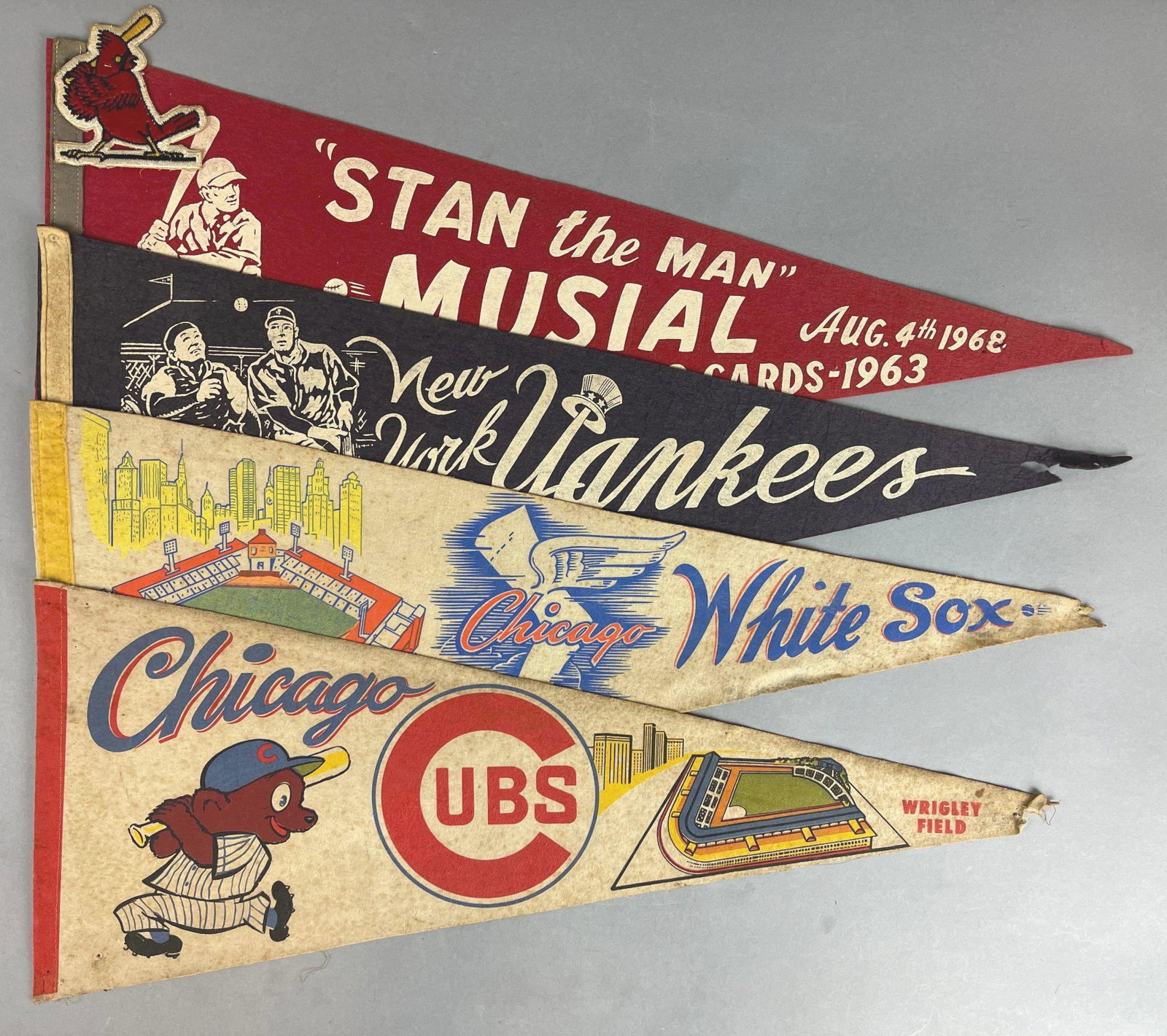 1960s New York Yankees, Chicago Cubs, and White Sox + Stan The Man Musial HOF Induction Pennants: Yankees, Cubs, and White Sox pennants are damaged at the tips, 1968 Stan The Man Musial HOF Induction Pennant has St. Louis Cardinals Patch included, Largest measures 29 inches