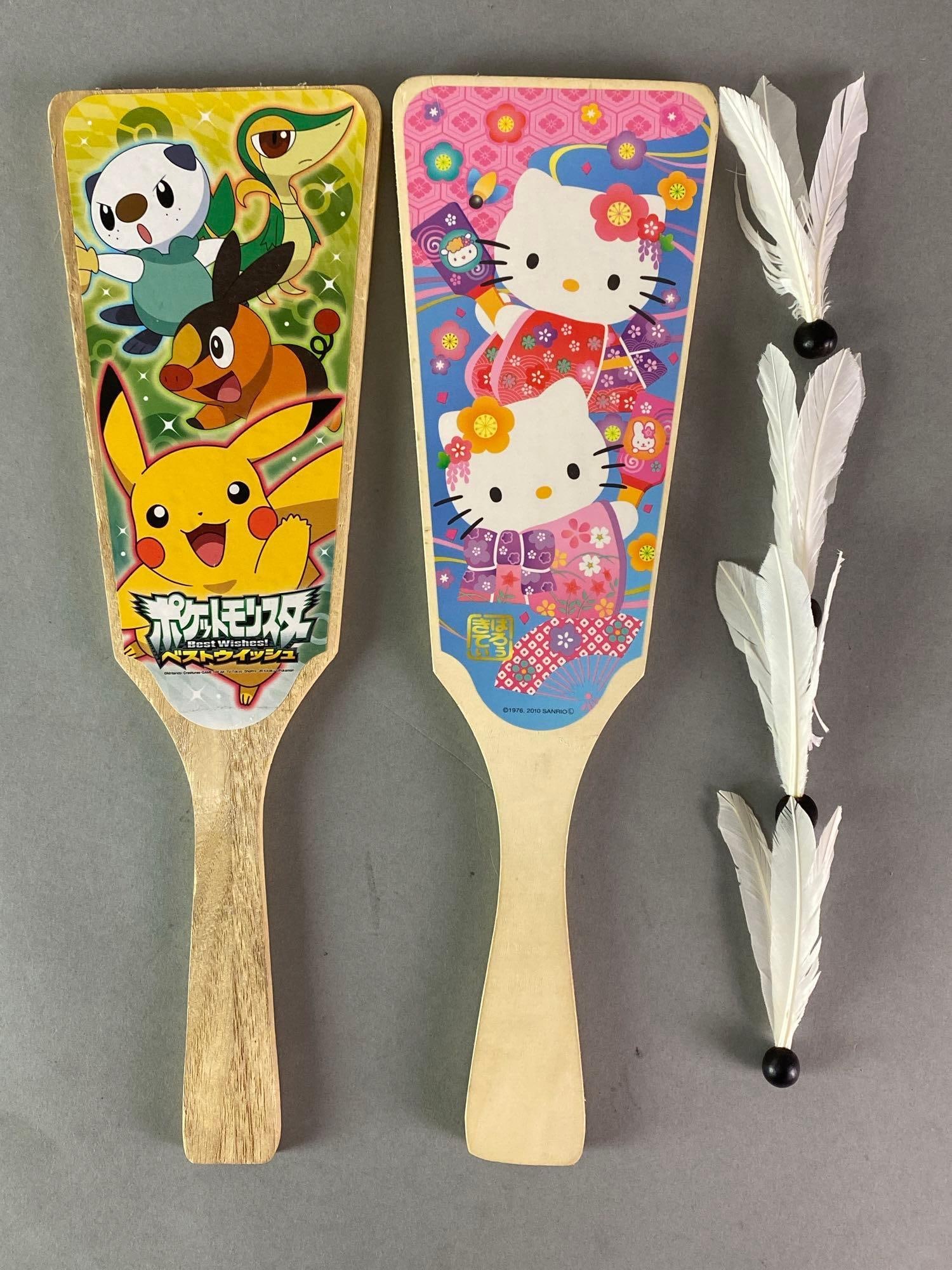 Japanese Childrens Hagoita Game Sets: Includes 2 paddles, and 4 shuttlecocks, Includes Pokémon and Hello Kitty paddles, Paddles measure 13 3/4 x 4 1/4 inches.