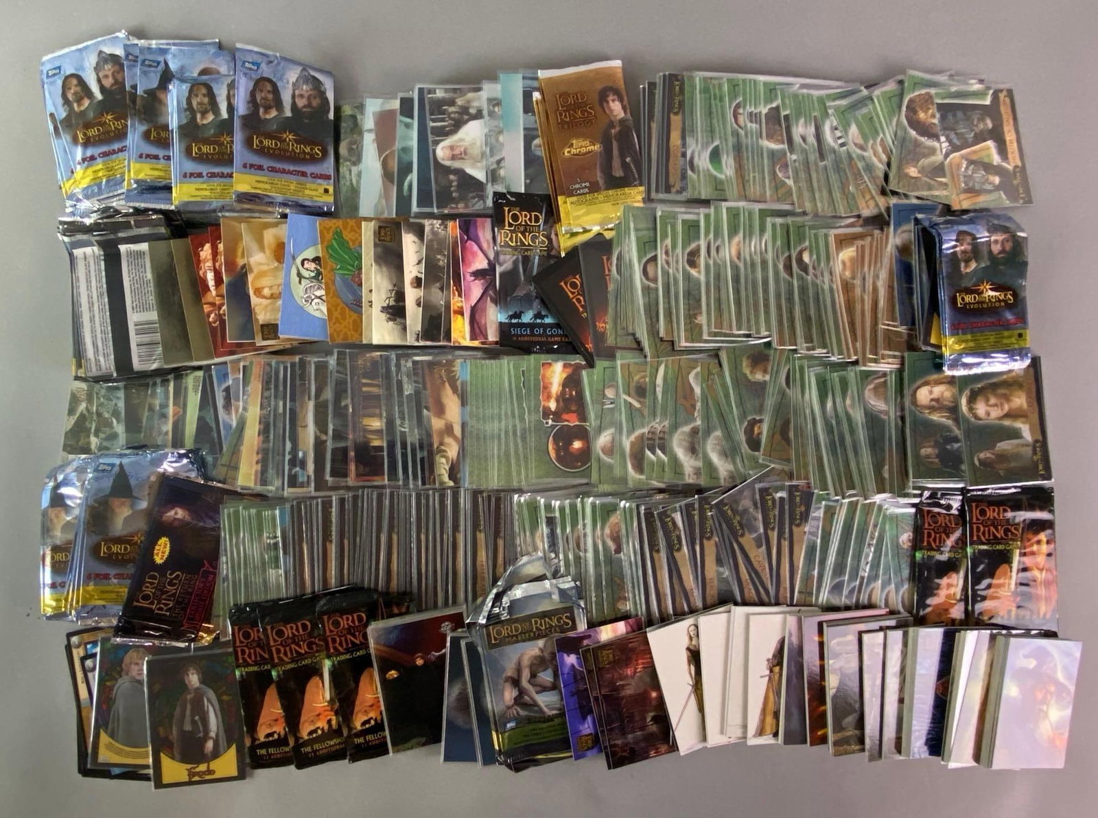 Large Group of Topps Lord of the Rings Trading Cards: Includes character cards, scene cards, empty foil packs, stained glass style cards, and more.