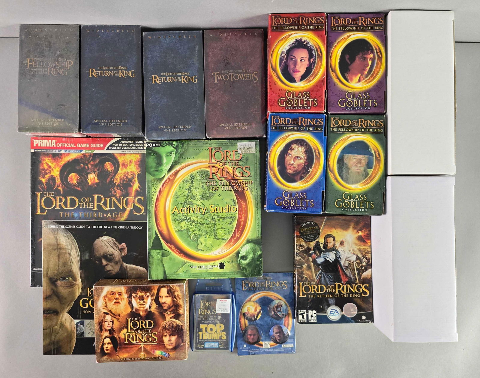 Group of 17 Lord of the Rings VHS Tapes and More: Includrs Glass Goblets, video game, trading cards and more, largest measures 10 x 8 inches