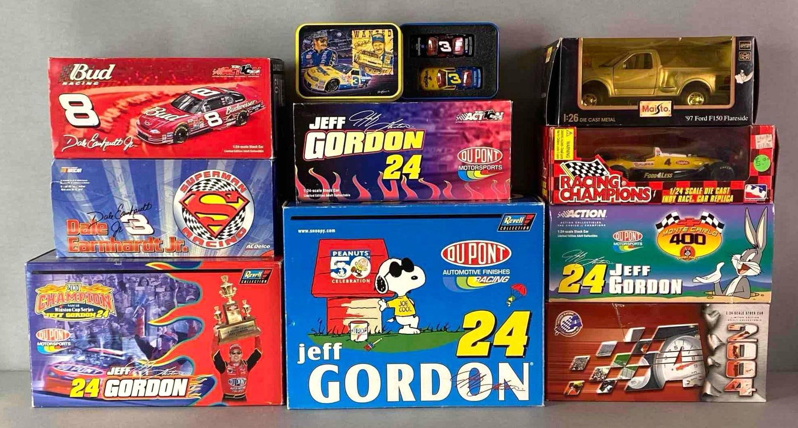 Group of 10 Assorted Die-Cast Vehicles: 1/64 - 1/28 scale, Includes Action Stock Cars, Revell, Racing Champions, and more, Largest box measures 9 1/4 x 11 3/4 x 6 inches.