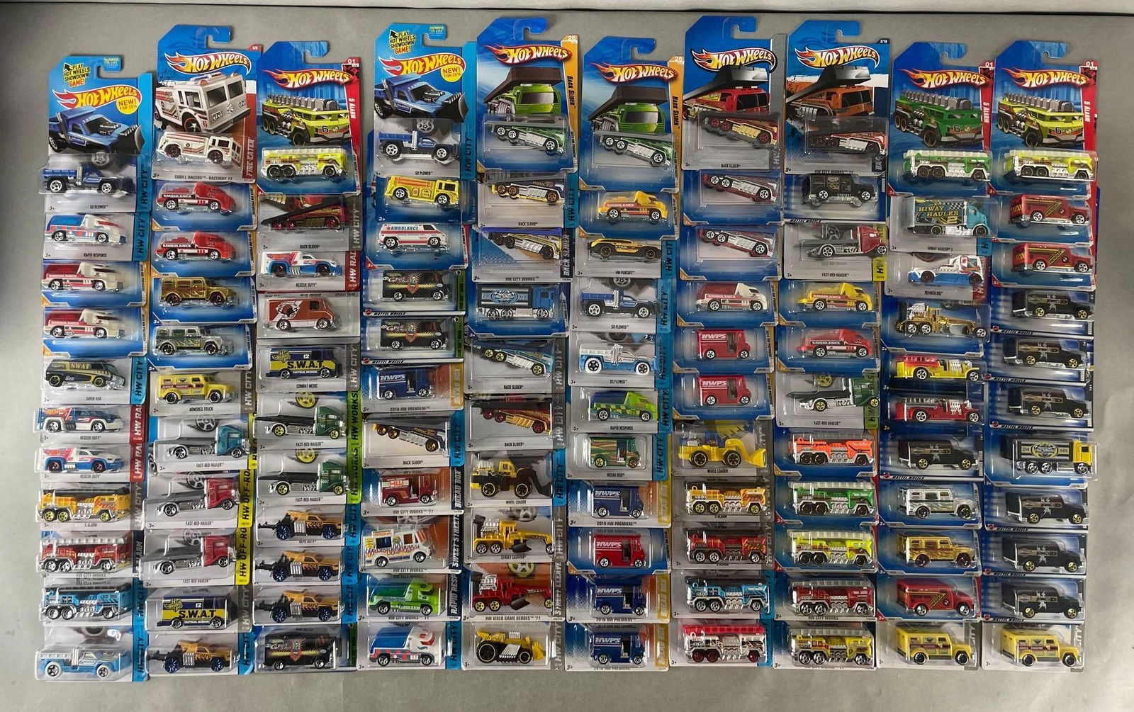 Group of 100+ Mattel Hot Wheels Die-Cast Trucks: Includes bread box, hw city, wheel loader, repo duty, and more