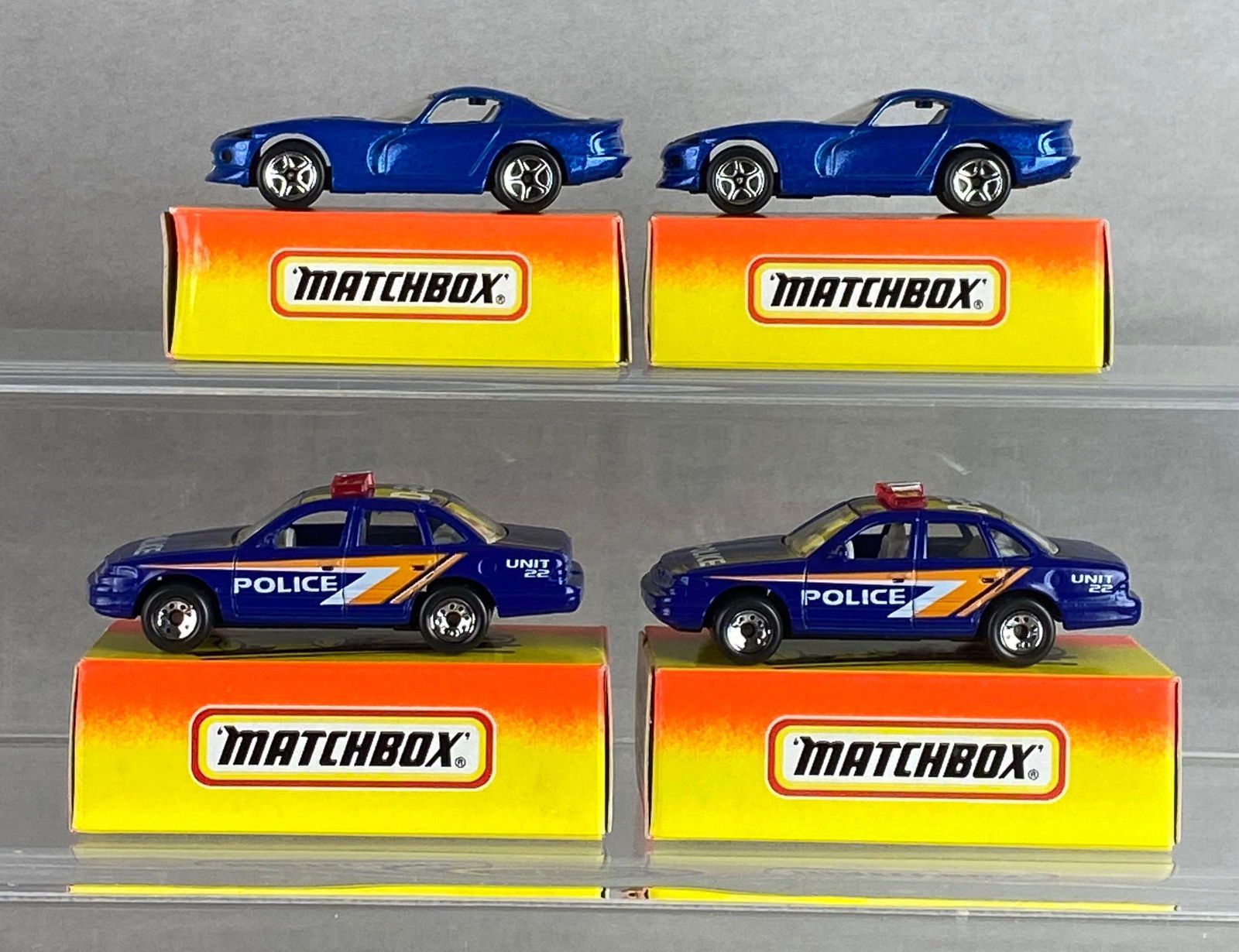 Group of 4 Matchbox No. 1 and 54 Die-Cast Cars: With boxes, A Lesney Product, made in England, Color: blue, clear windows, silver bases, black plastic wheels