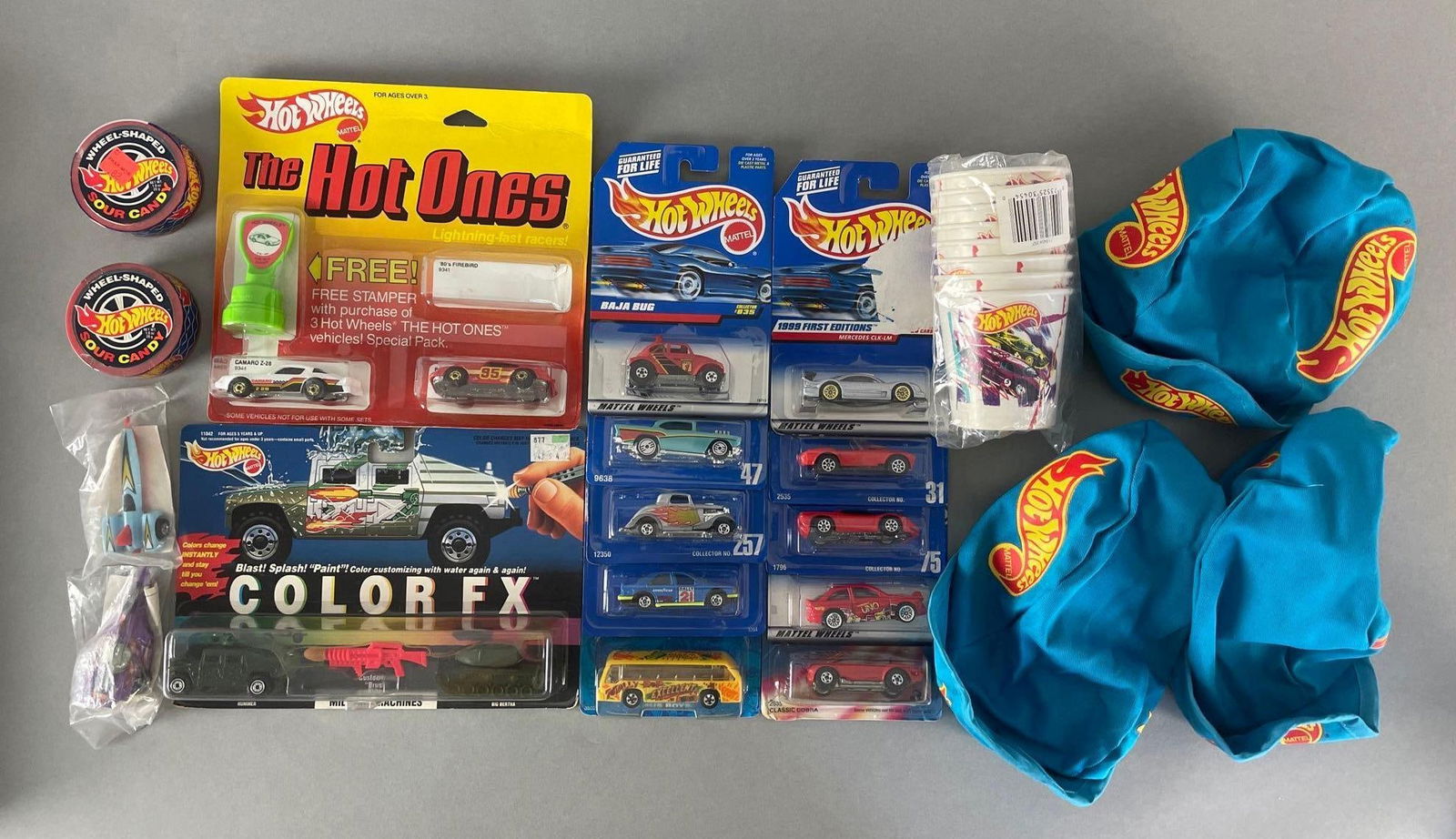 Group of 20+ Mattel Hot Wheels Items: Includes die-cast vehicles, bicycle hats, cups, and more. 1/64 scale