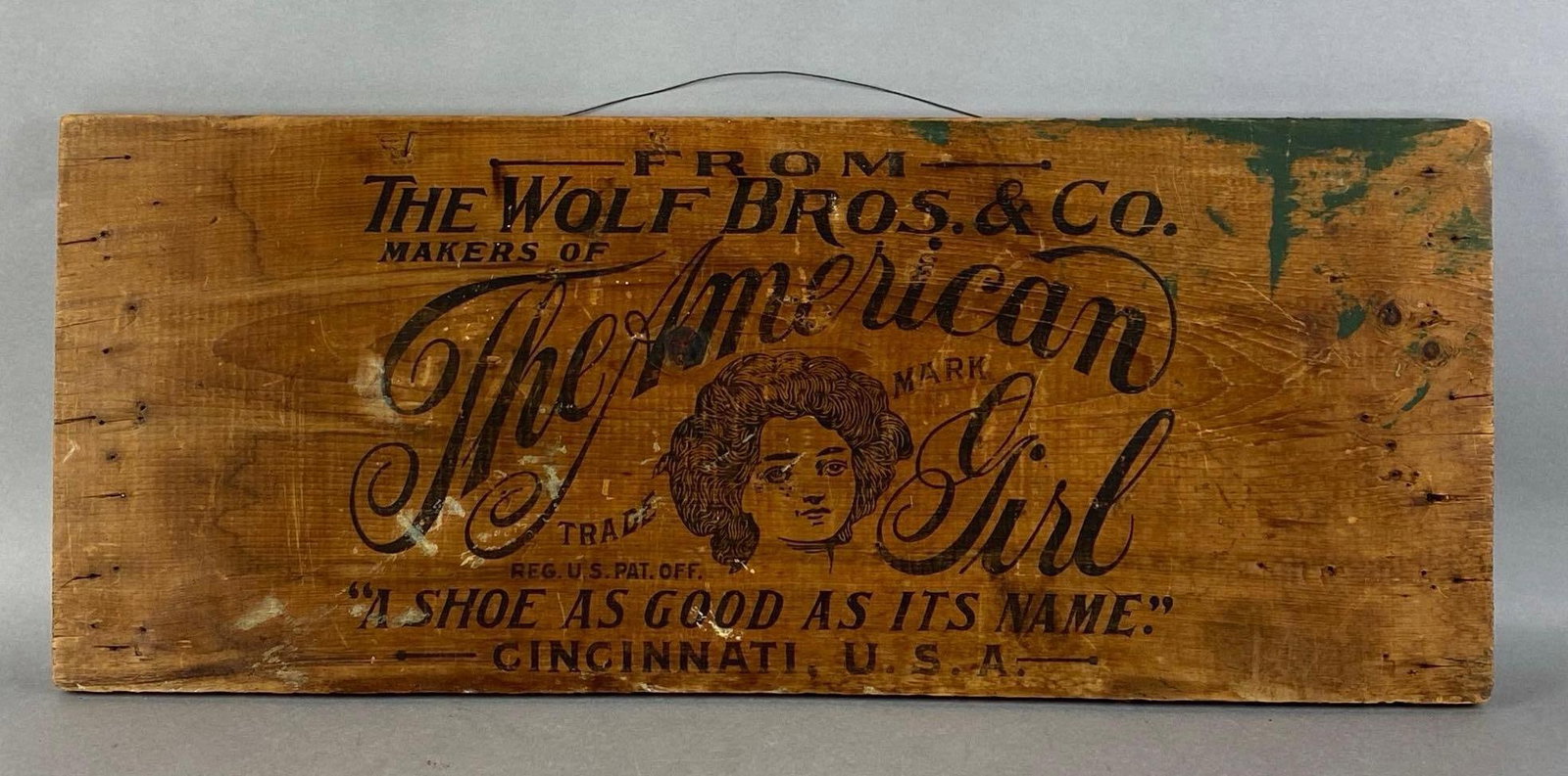 The American Girl Shoe Cincinnati, Ohio Wood Advertising Sign: The wolf bros and Co, measures 11 1/2 x 29 inches