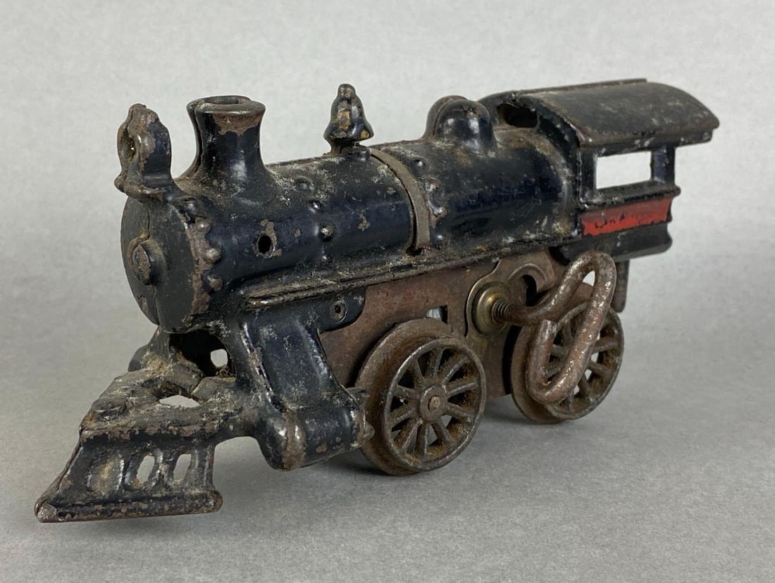 Vintage Hafner Cast Iron Wind-Up Locomotive: in working condition, measures 3 1/4 x 7 x 3 inches