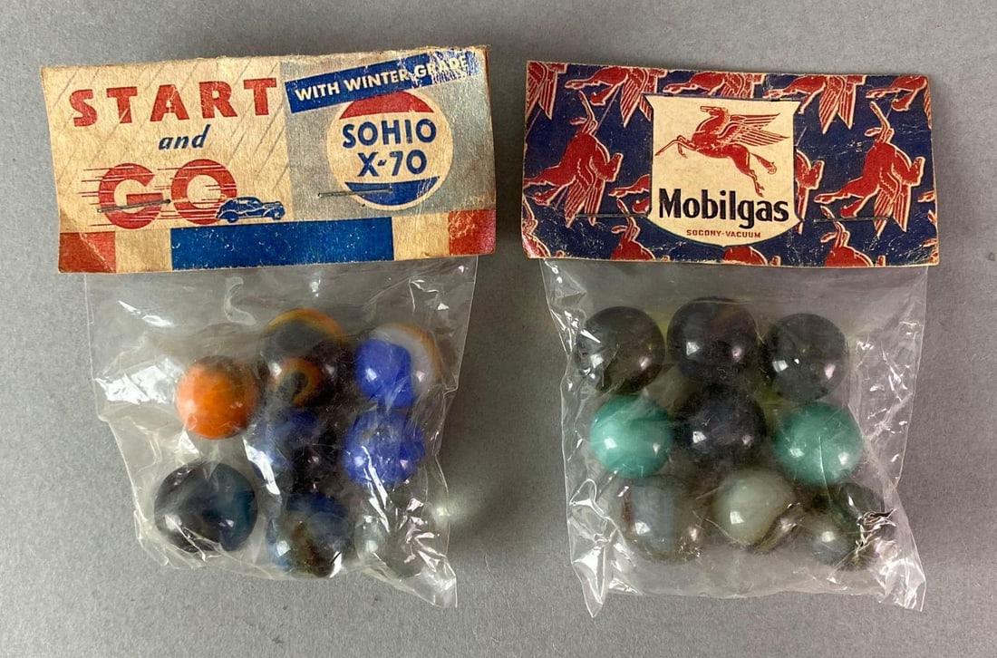 Group of 2 Motor Oil Advertising Marble Sets: Unknown authenticity, Includes Sohio X-70 Start and Go, and Mobilgas, Packaging measures 3 1/2 x 2 3/4 inches.