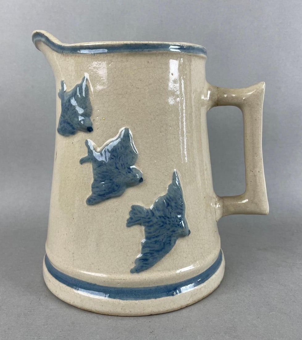 Stoneware Embossed Bluebird Pitcher: Handle repaired, crack at spout, measures 8 1/2 x 8 1/4 x 6 3/4 inches