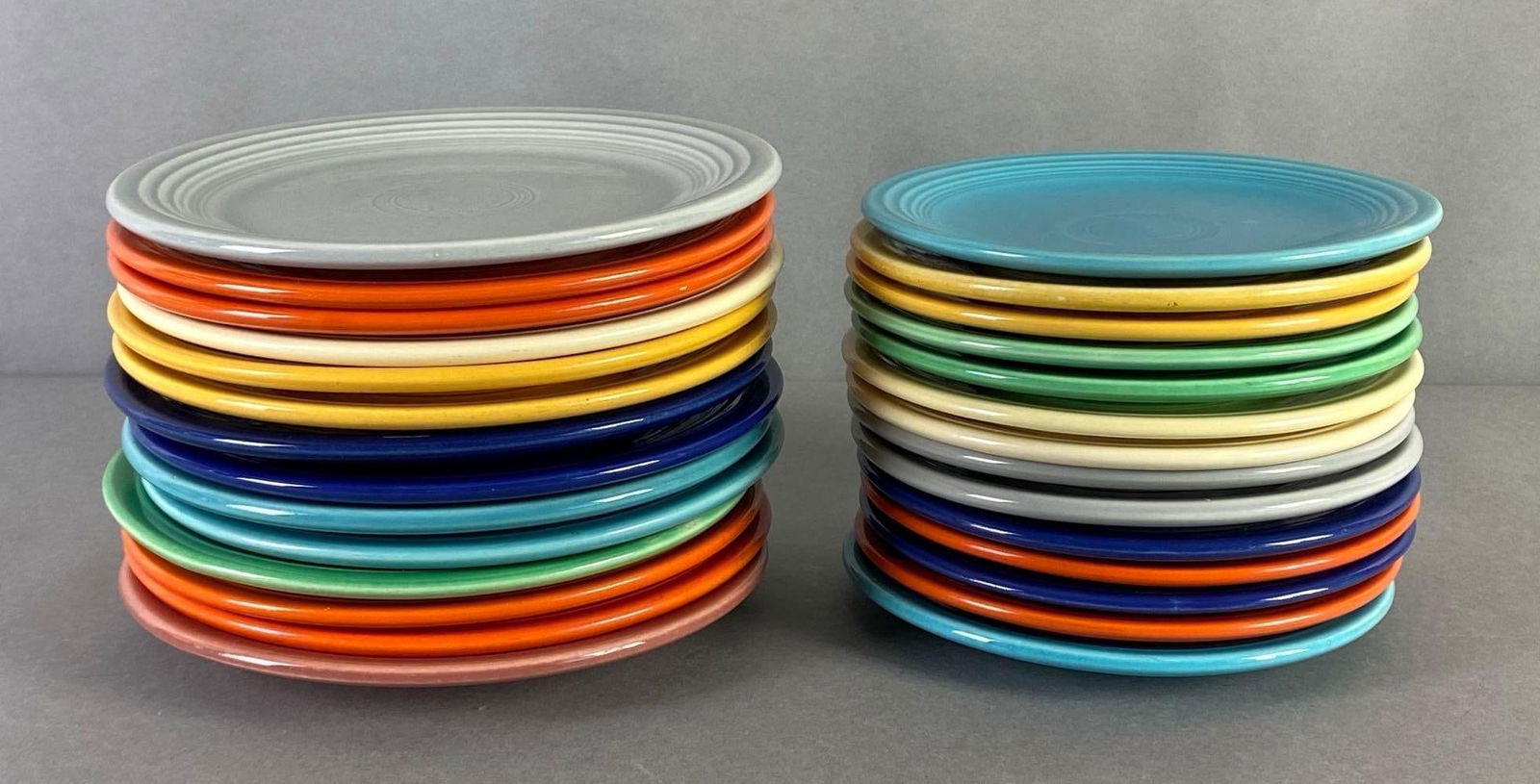 Group of 20+ Small Fiestaware Plates: Includes 2 sizes, Largest measures 7 1/2 x 7 1/2 x 3/4 inches, Smaller plates measure 6 1/4 x 6 1/4 x 3/4 inches.