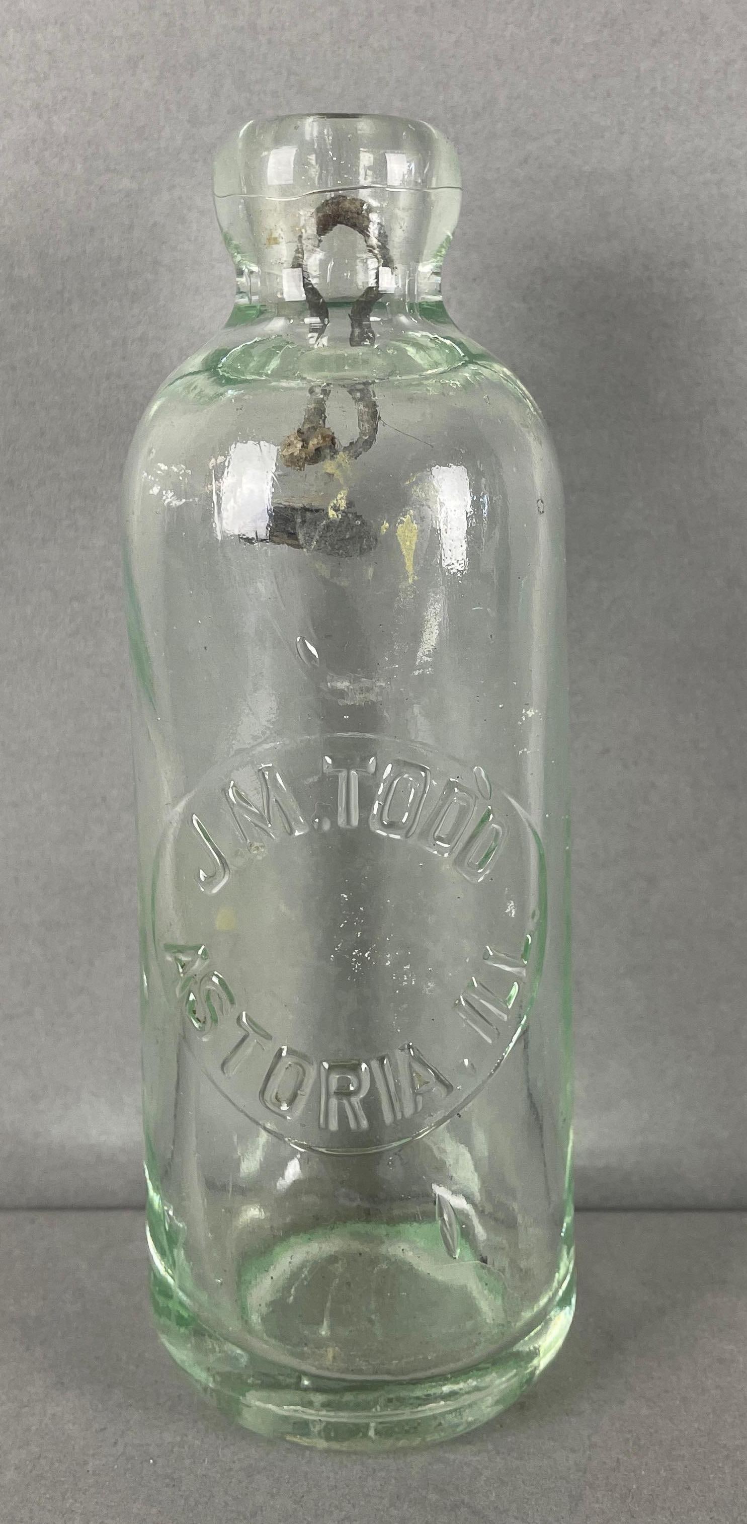 J.M. Todd Astoria Illinois Hutchinson Bottle: Astoria, IL. 16 on bottom, stopper stuck in top. Measures 7 x 2 1/4 inches