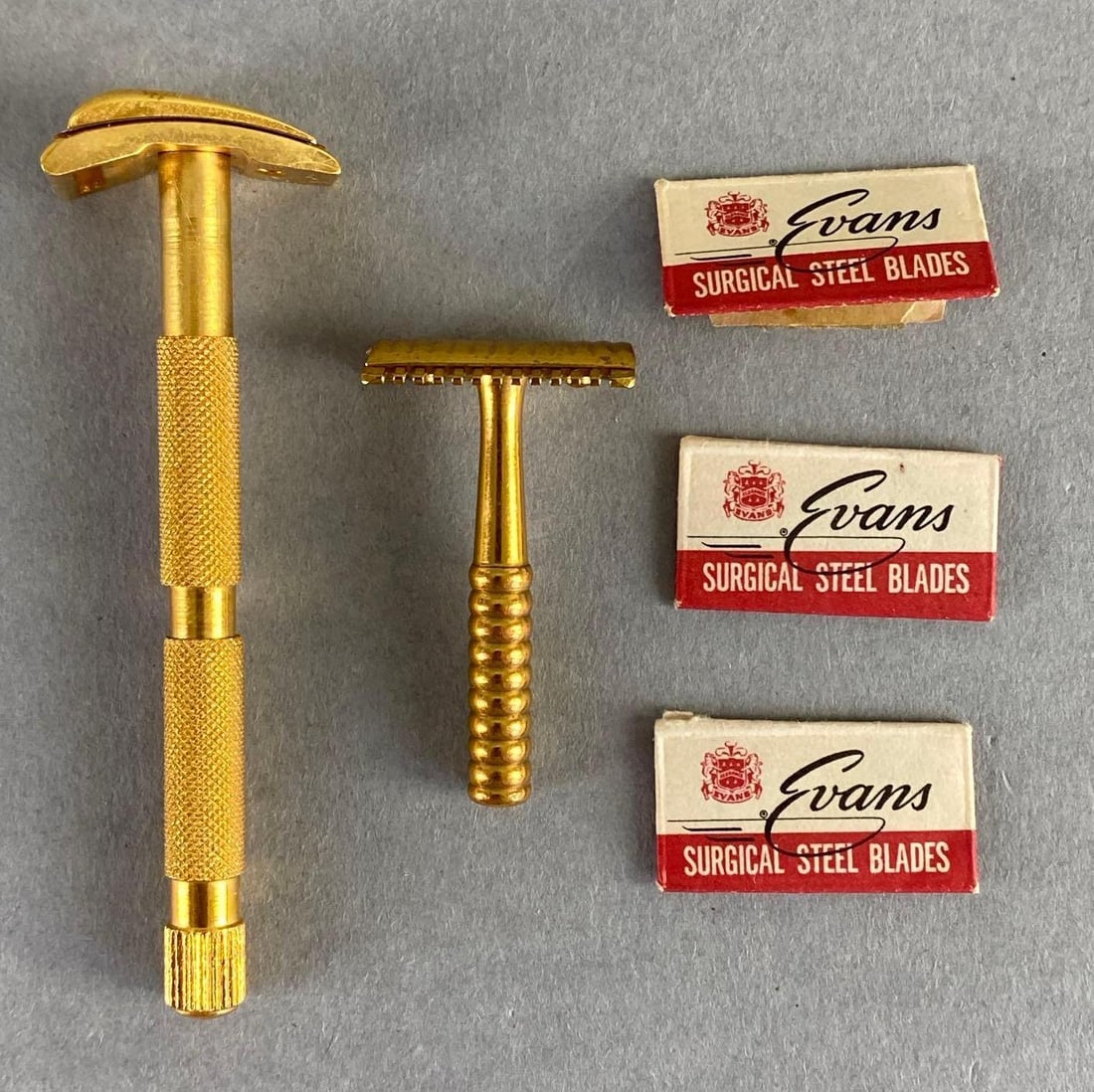 Group of Gold Tone Razors and Blades: Includes 3 blades in original packaging, Largest razor measures 3 x 1 x 3/4 inches.