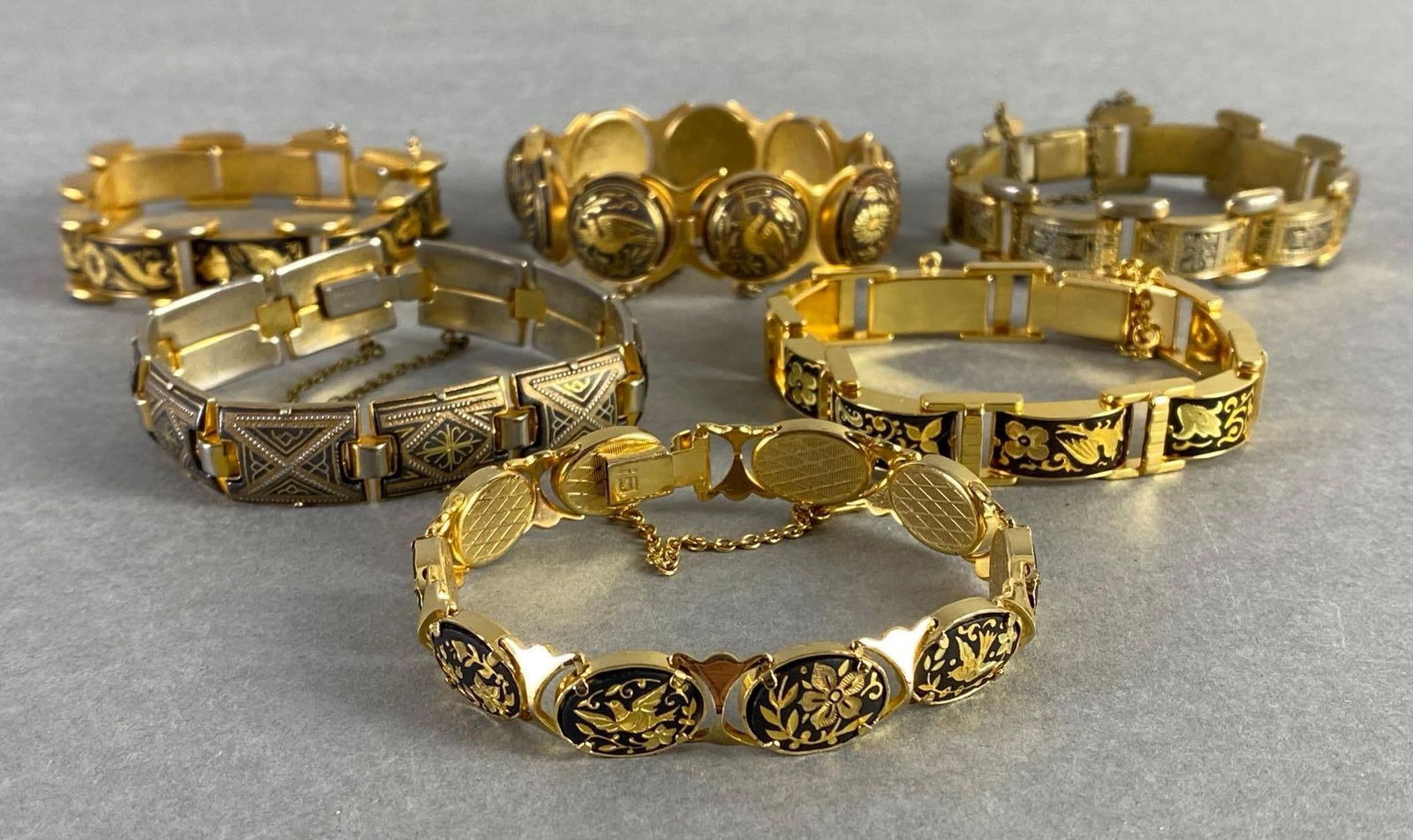 Group of 6 Damascene Link Bracelets: Some missing extender chain, Longest measures 7 1/2 inches around.